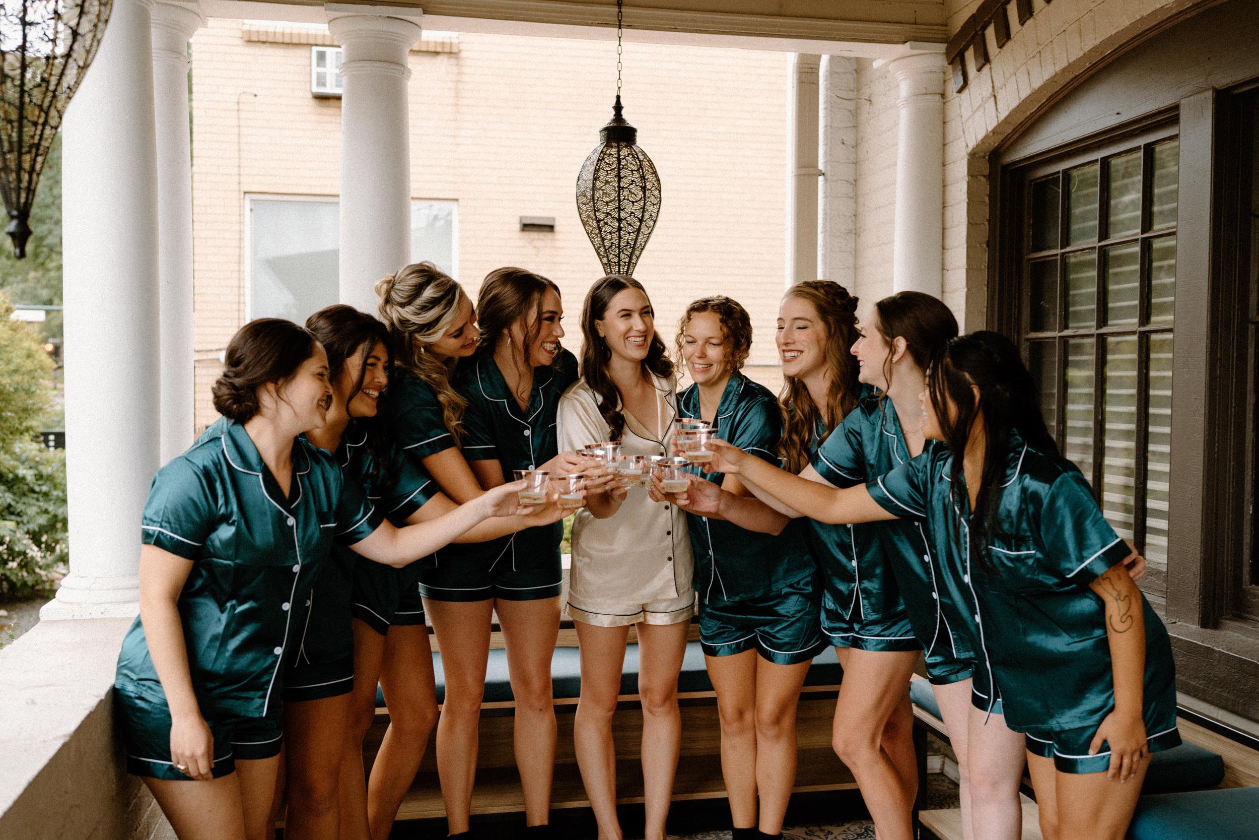 The bridal party raises their glasses of champagne in a toast