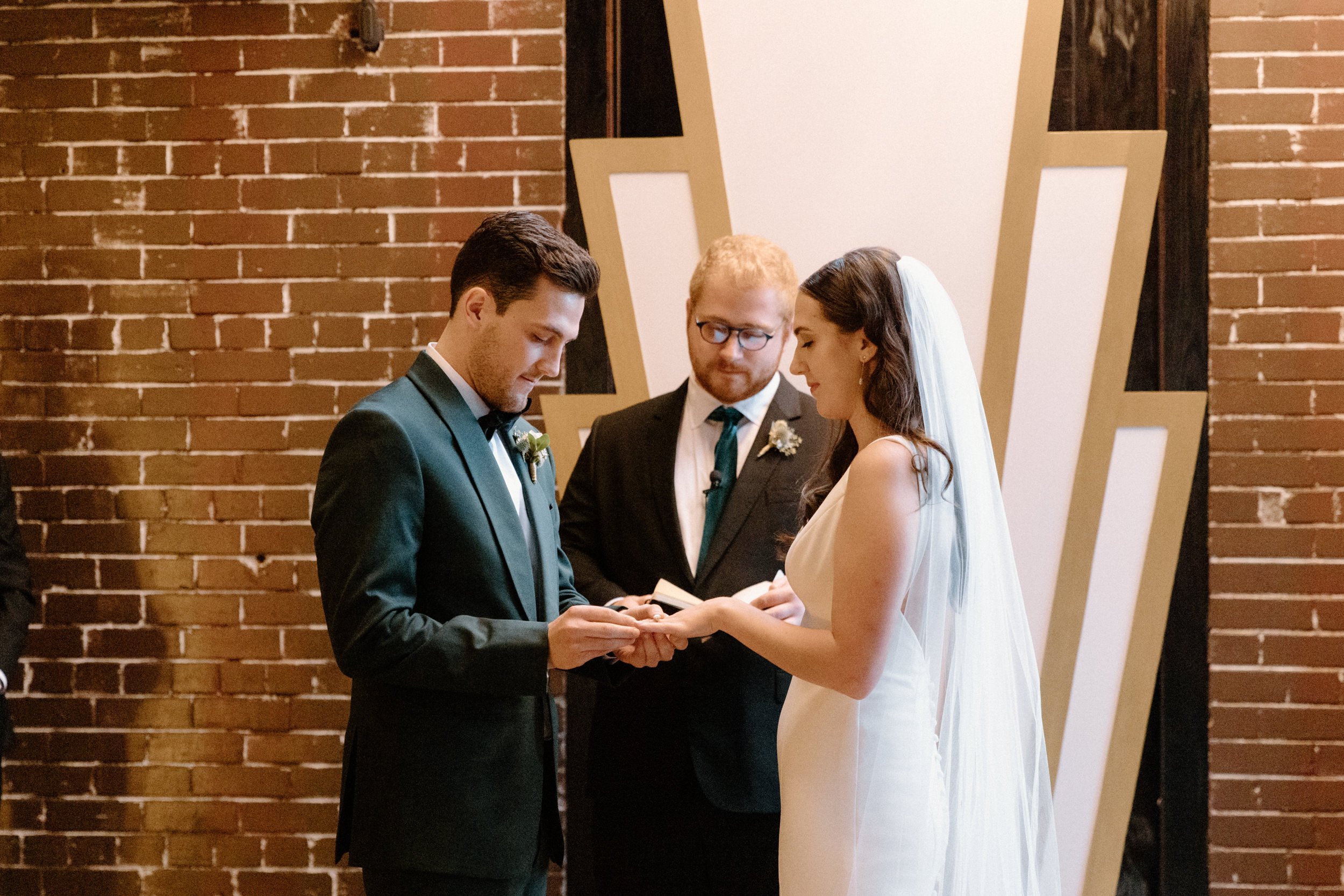 The groom places the ring on the bride's finger