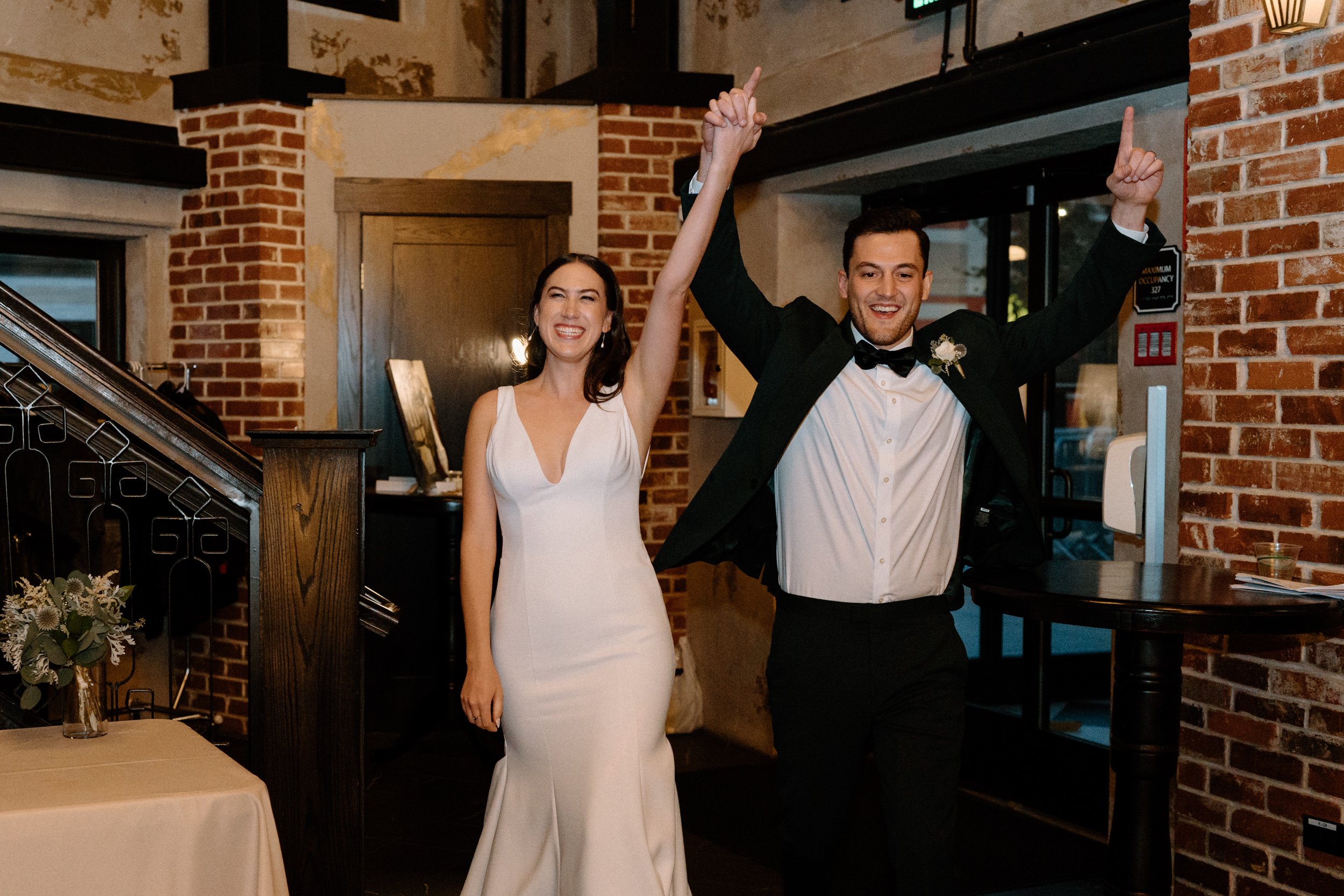 The bride and groom excitedly enter the reception