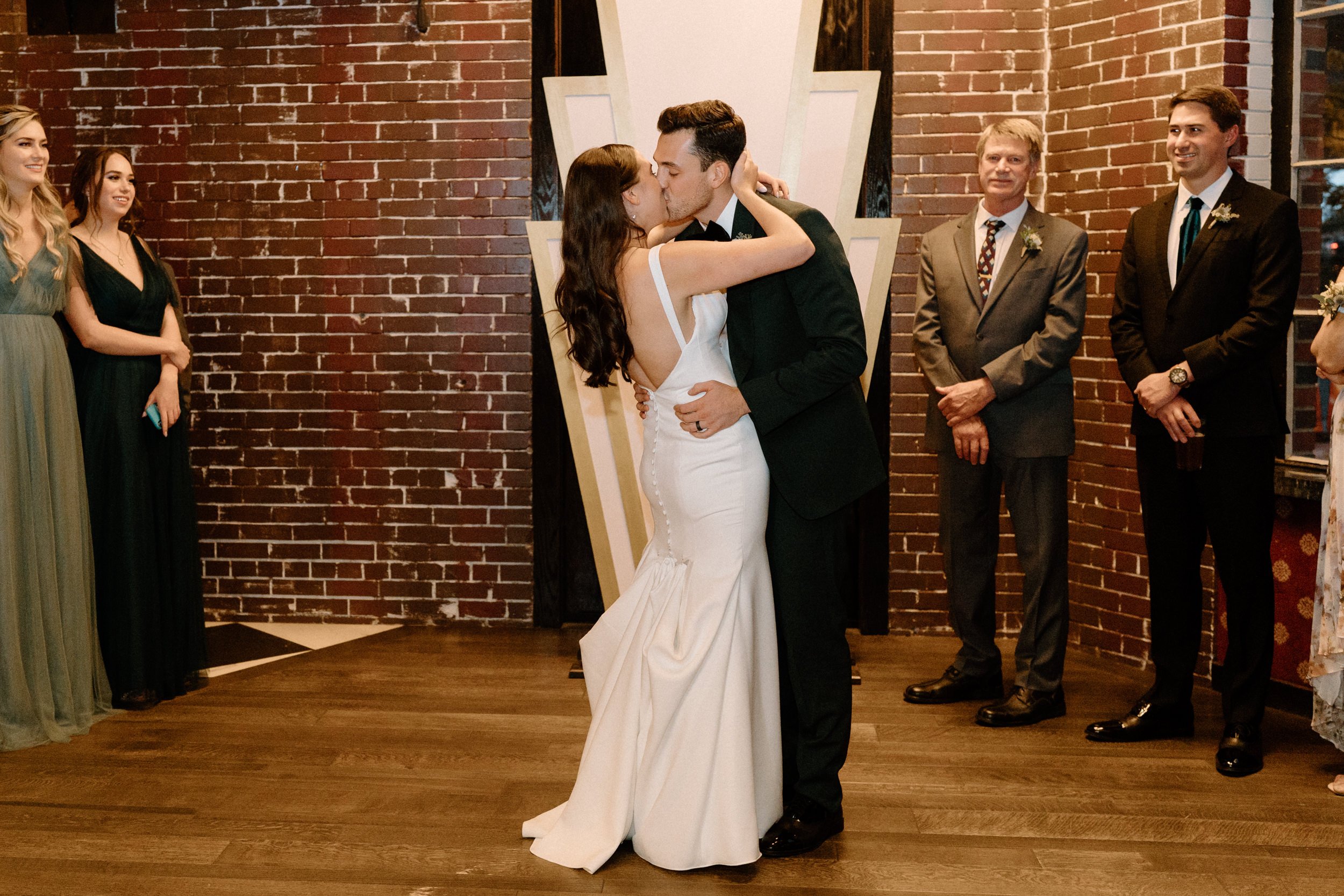 The bride and groom kiss during their first dance