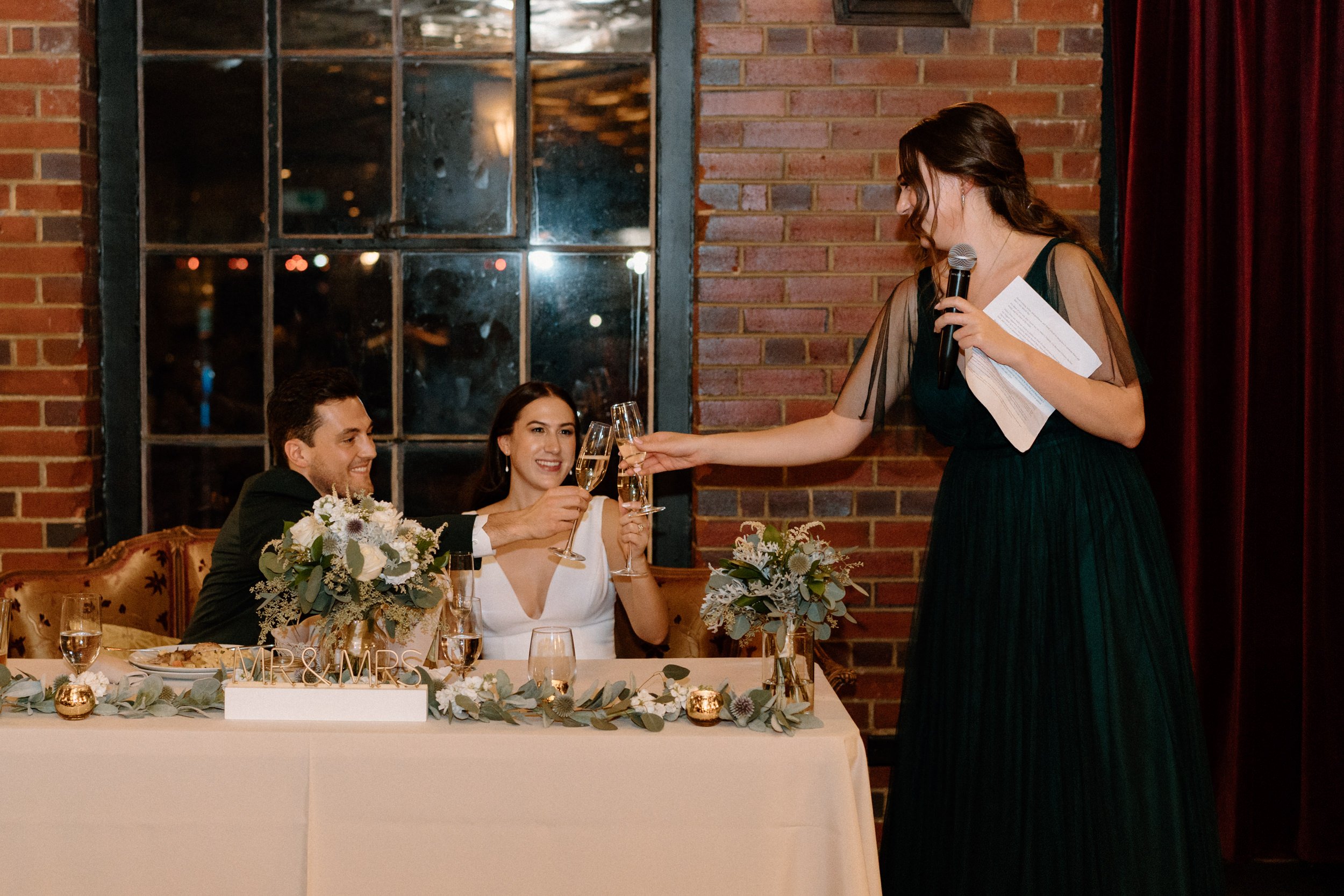 A bridesmaid makes a toast