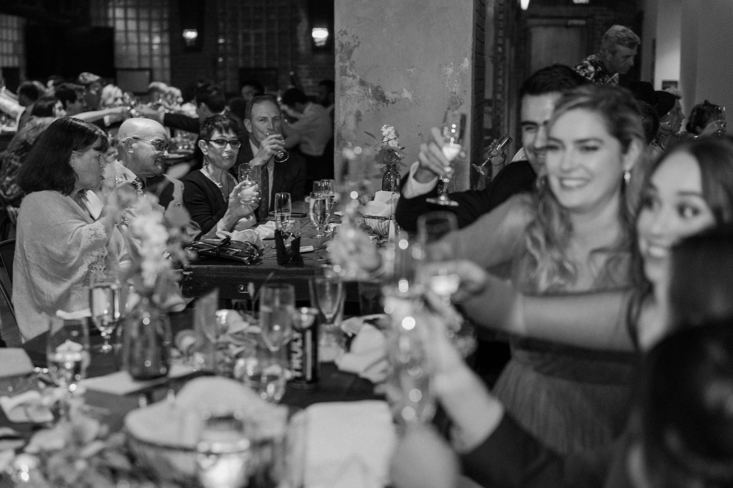 Wedding guests raise their glasses to toast