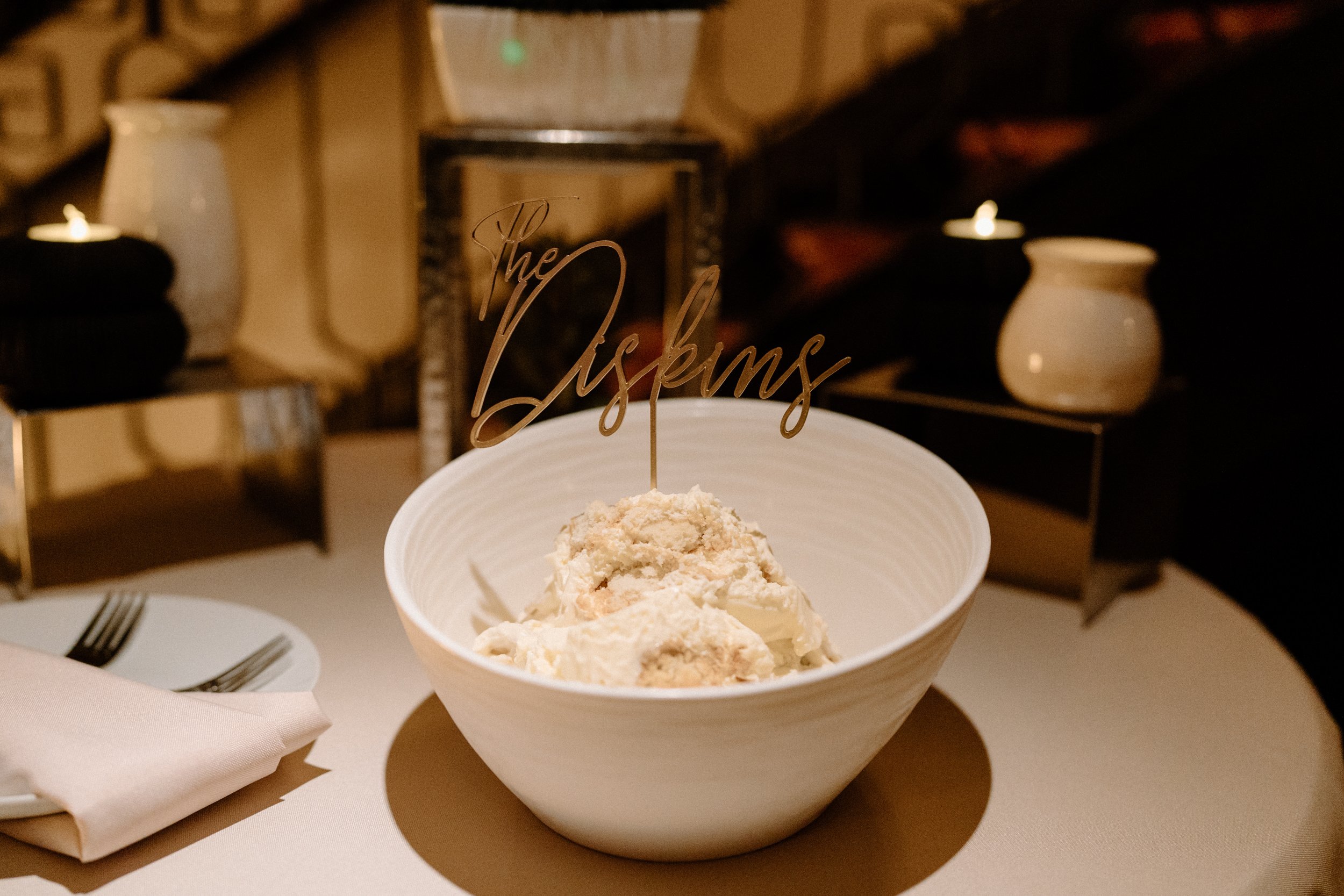 A bowl of vanilla ice cream with a sign that reads "The Diskins"