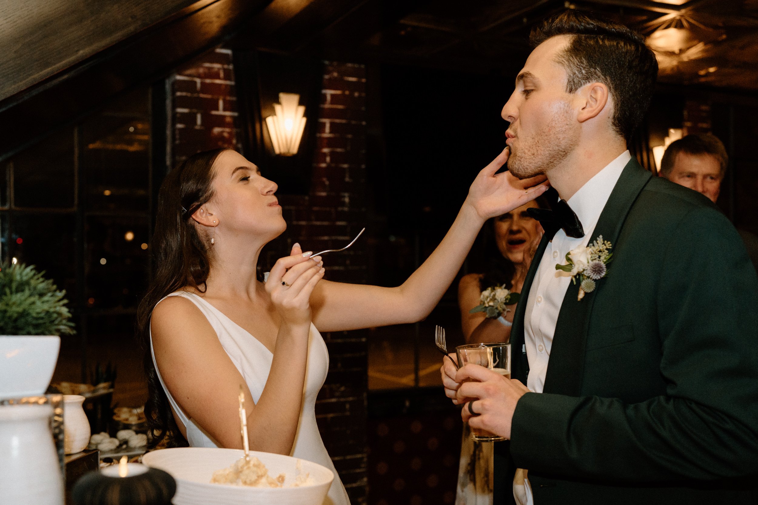 The bride feeds a piece of ice cream to the groom
