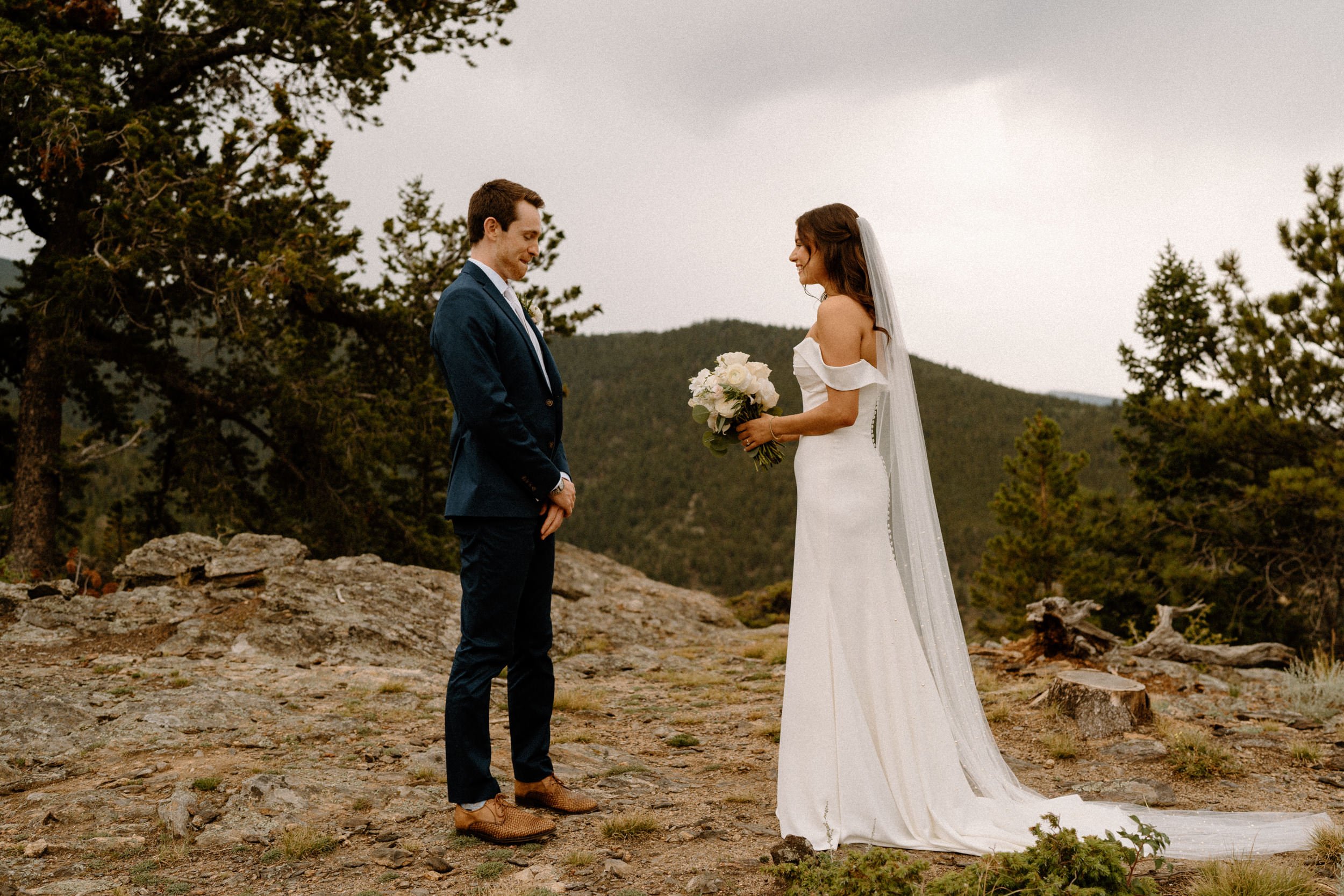 The groom turns to see the bride for the first time outside of North Star Gatherings in Idaho Springs, CO