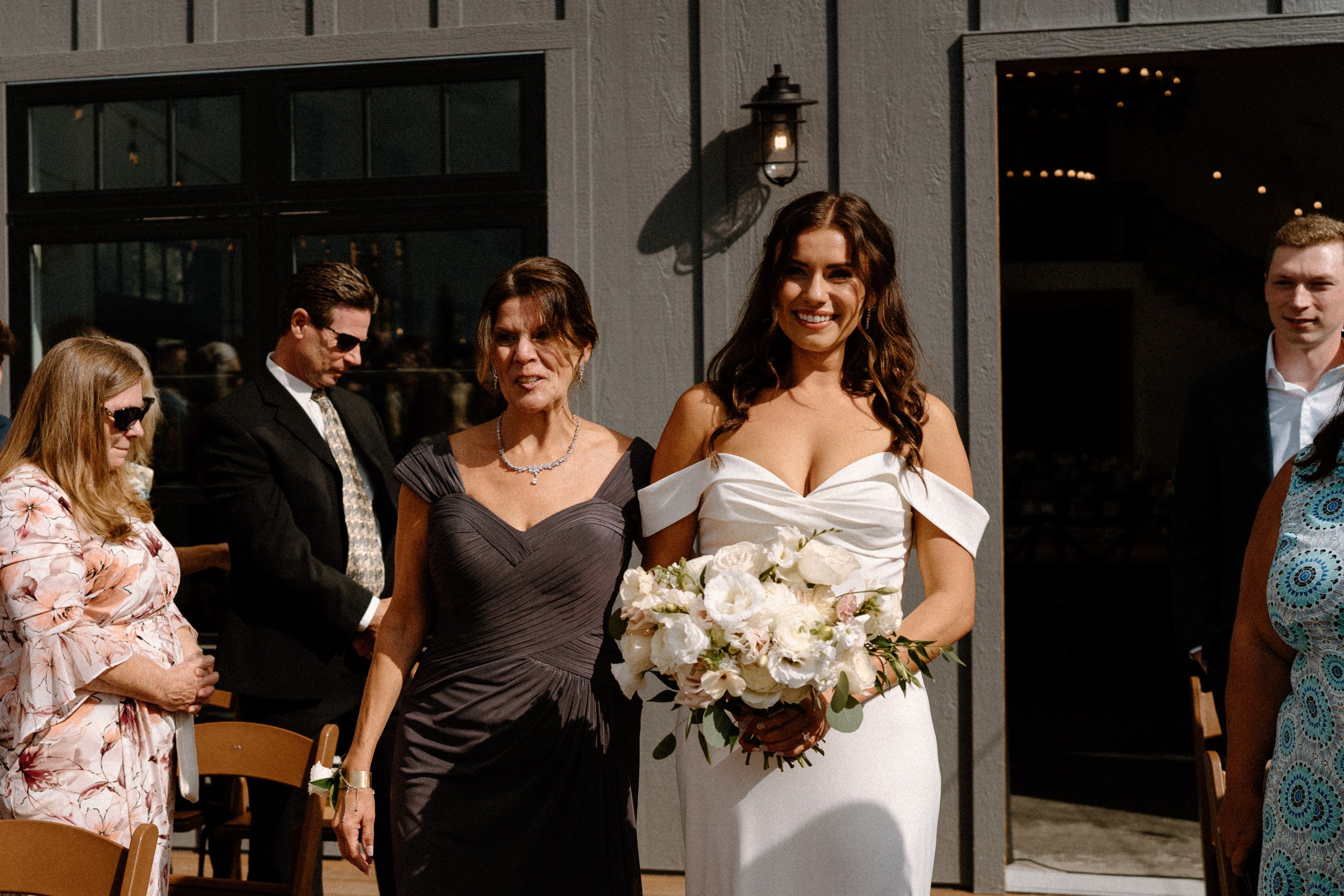 The bride and her mother walk down the aisle together at North Star Gatherings in Idaho Springs, CO
