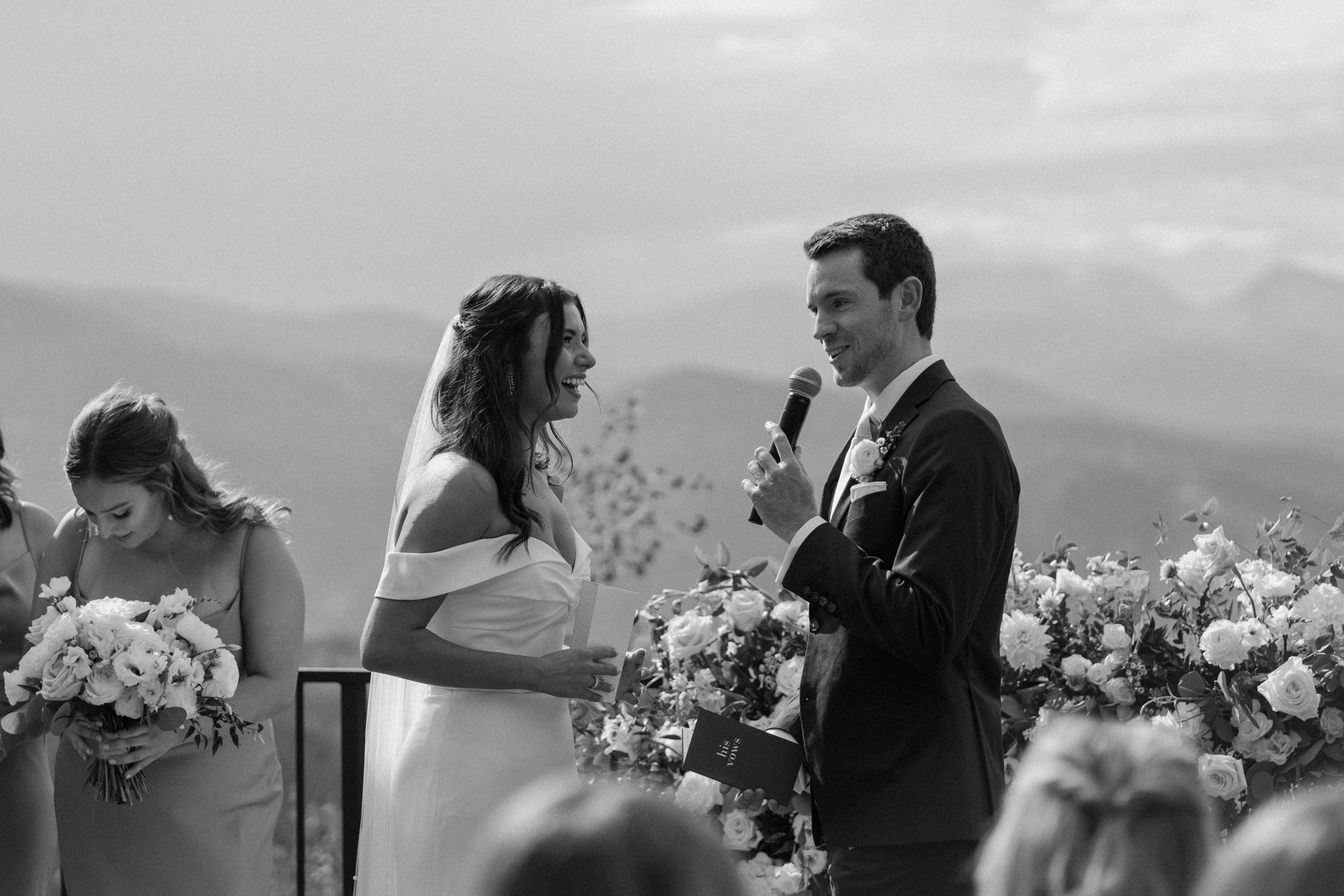 The groom says his vows as the bride laughs