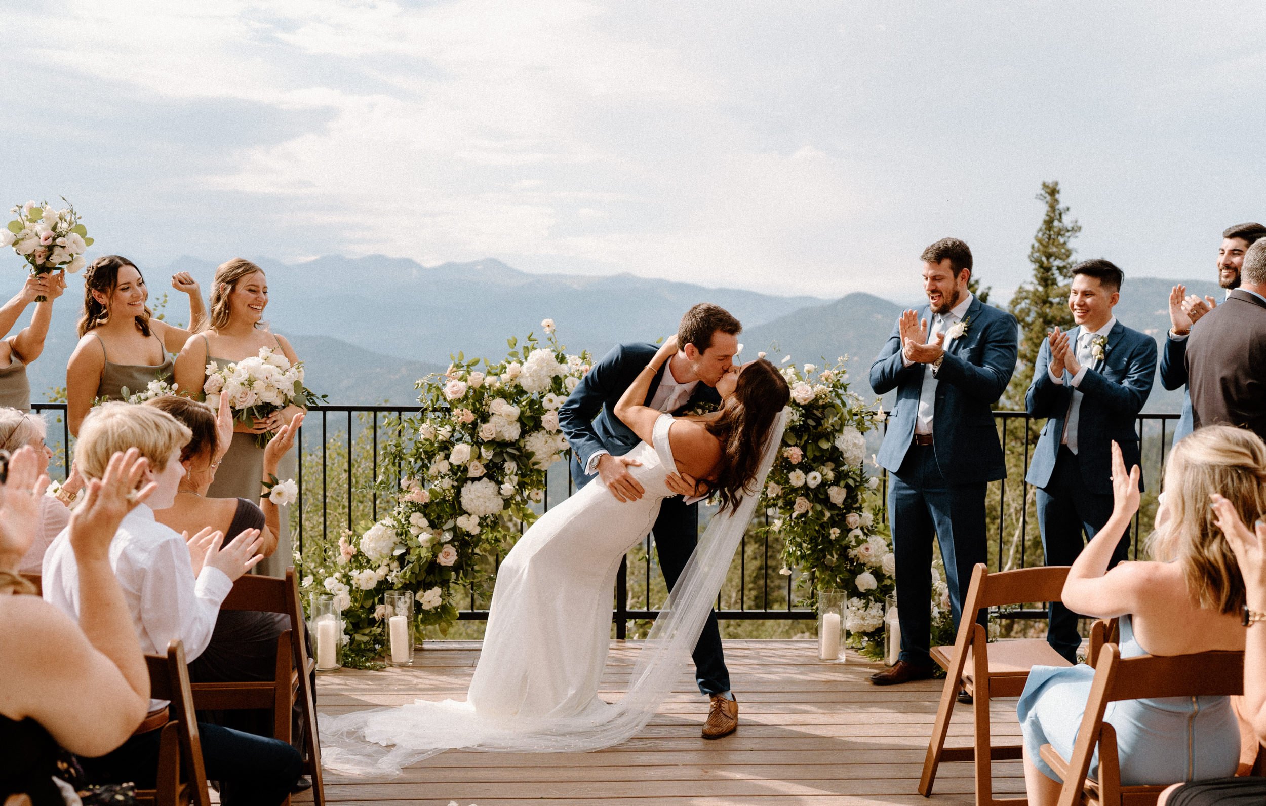 The groom dips the bride for their first kiss at North Star Gatherings in Idaho Springs, CO