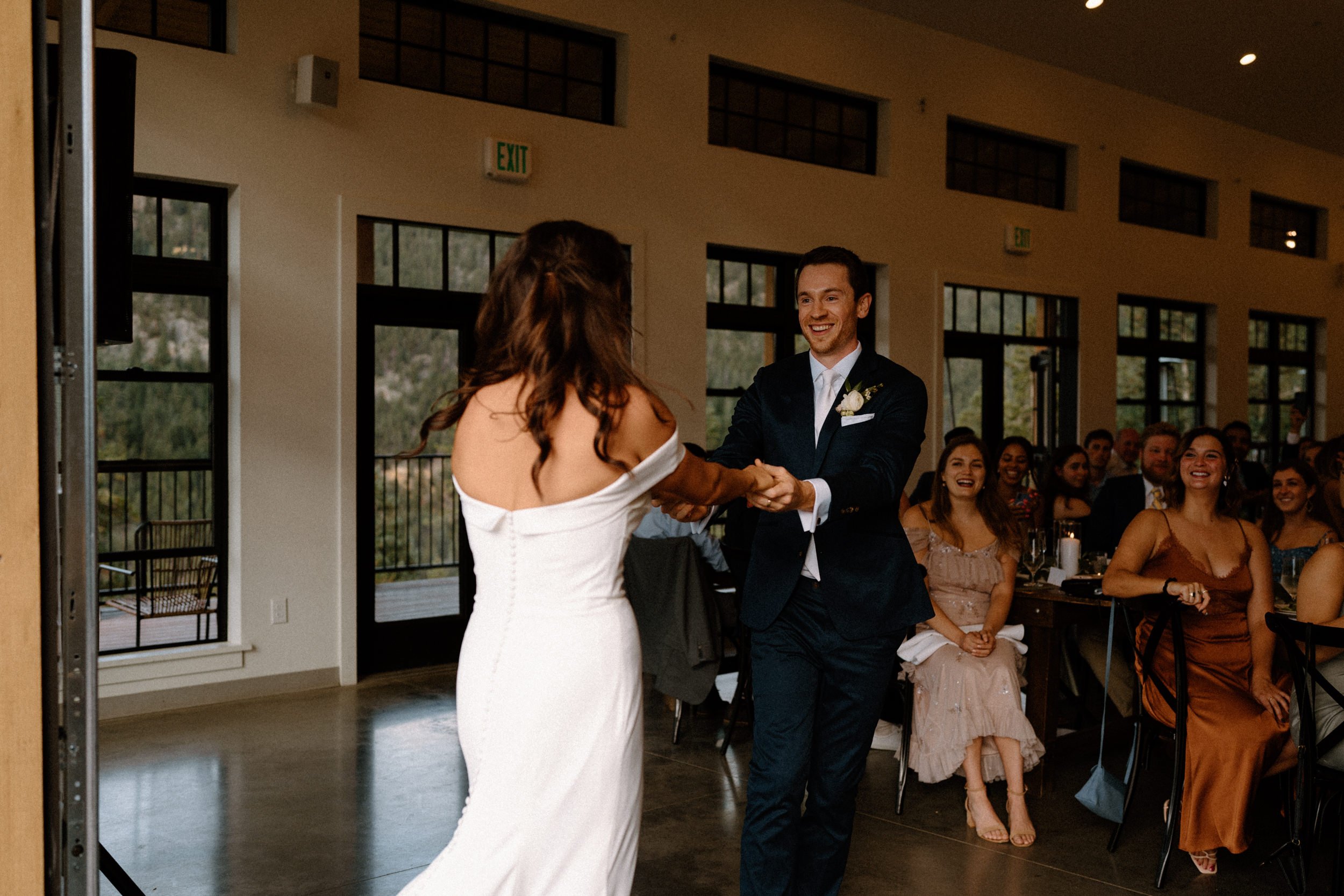 The bride and groom smile at each other during their first dance