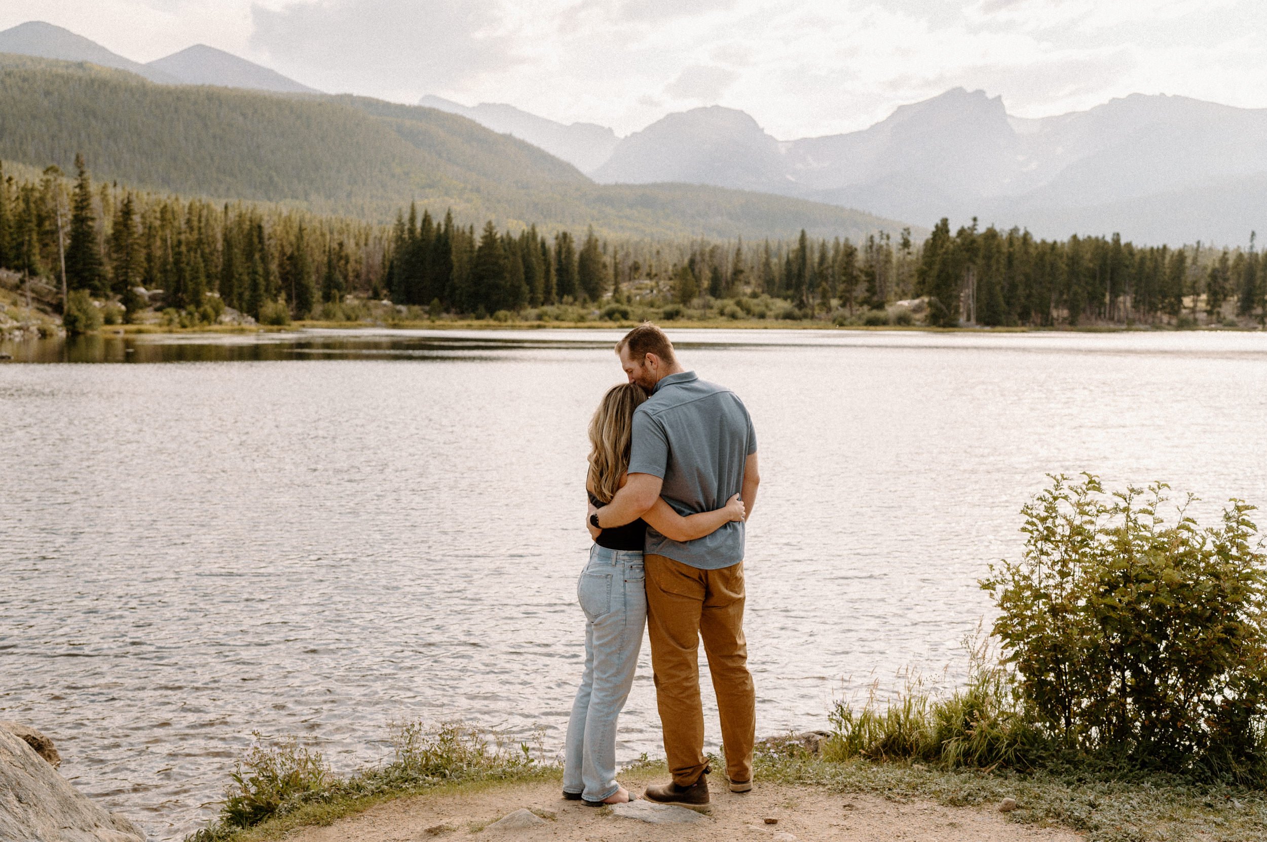 Man and woman overlook Sprague Lake at Rocky Mountain National Park
