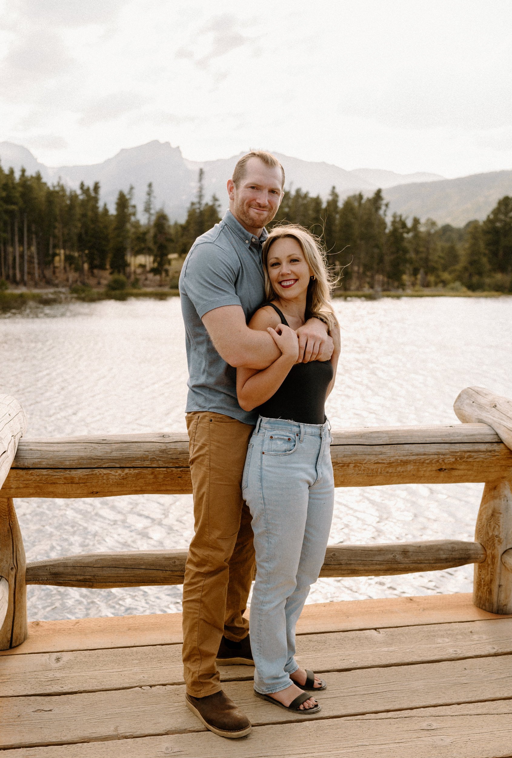Man and woman pose at Sprague Lake at Rocky Mountain National Park