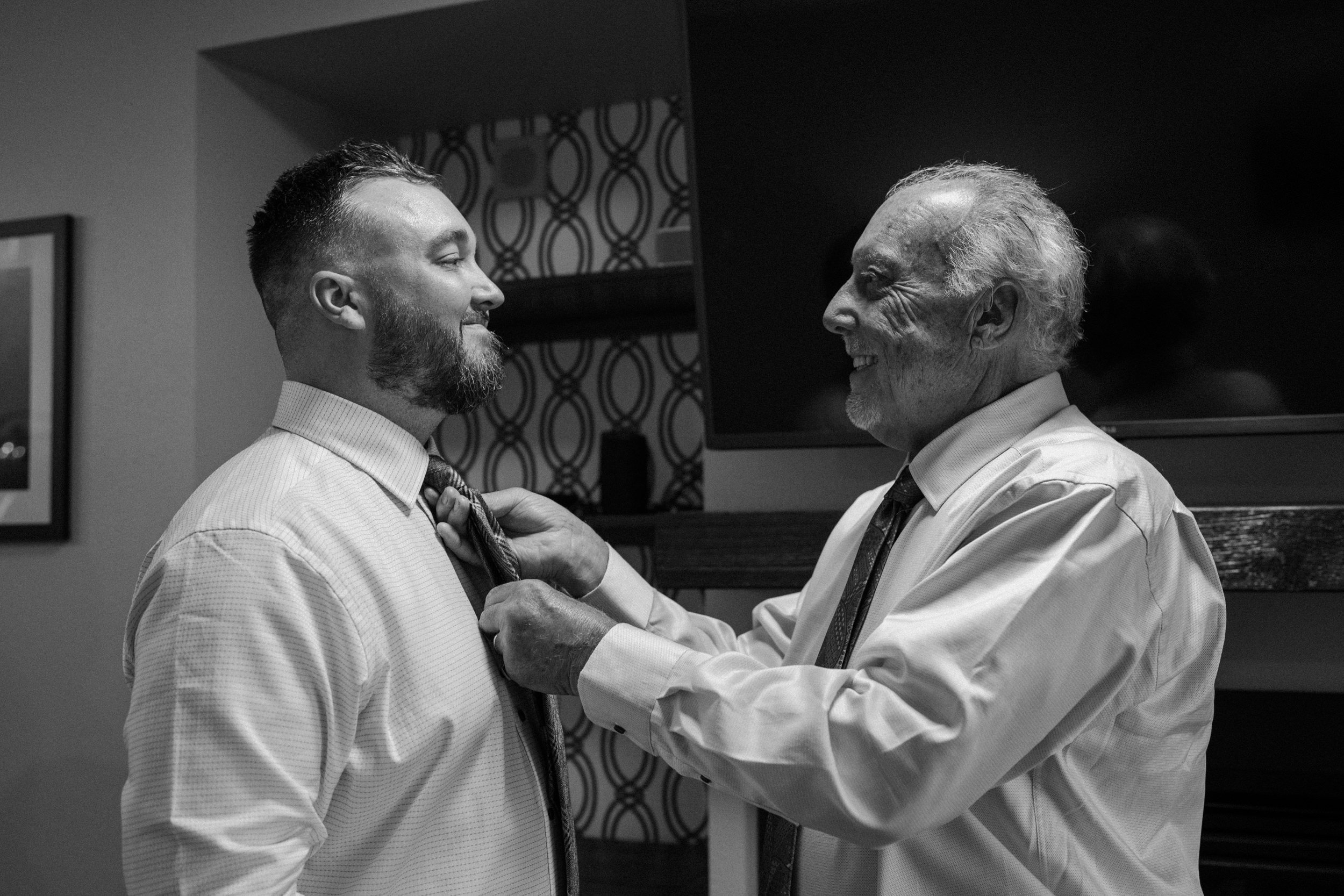 Father of the groom helps adjust his tie