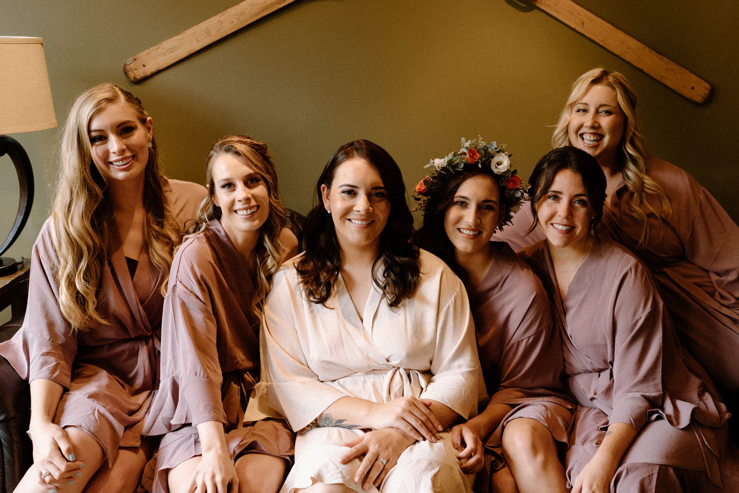 Bridal party poses in their matching robes while getting ready