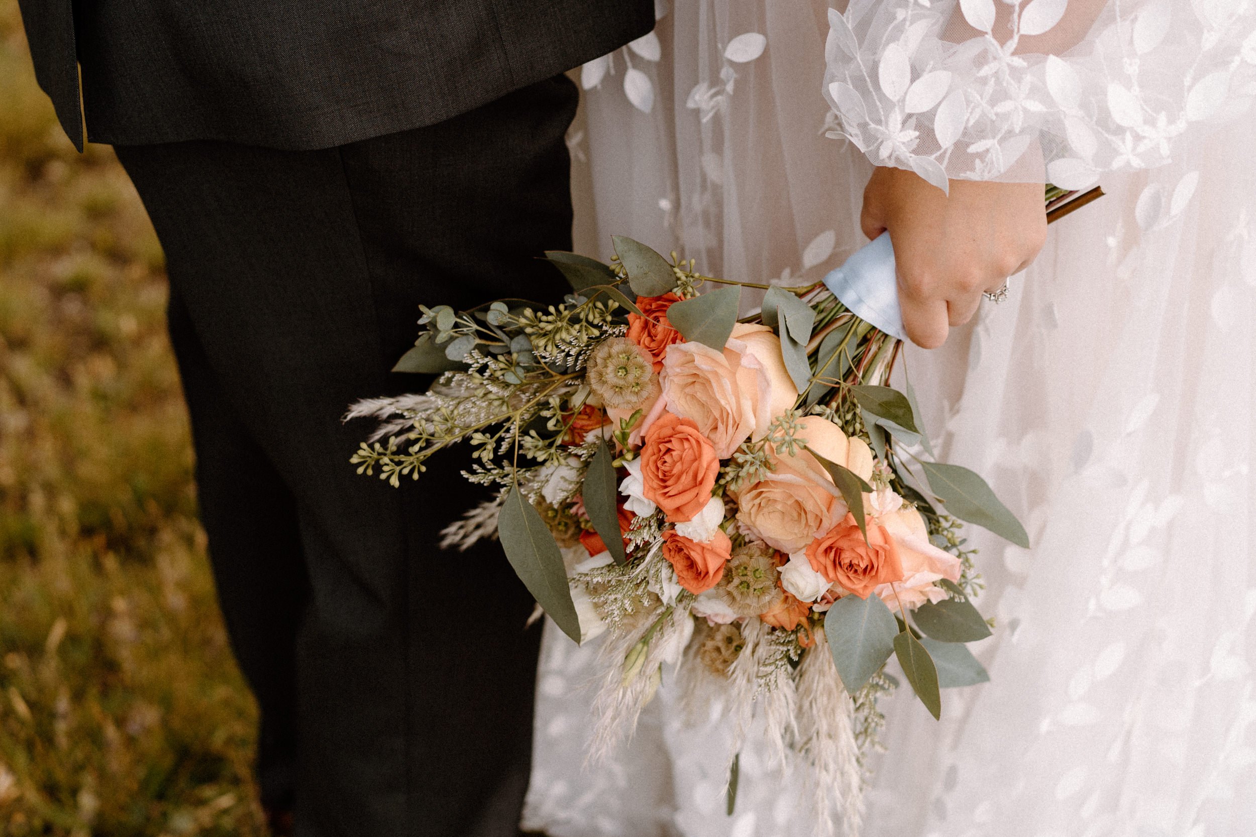 Close up of the bride's pink and orange bridal bouquet