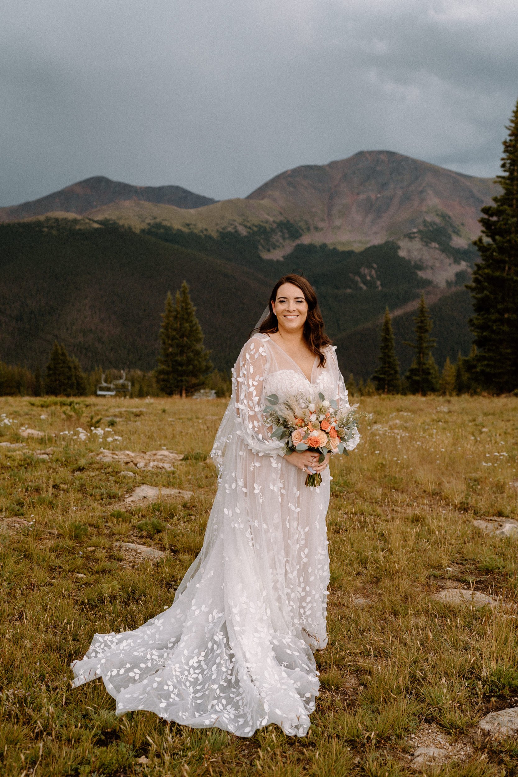 Bride poses on top of Lunch Rock in Winter Park, CO