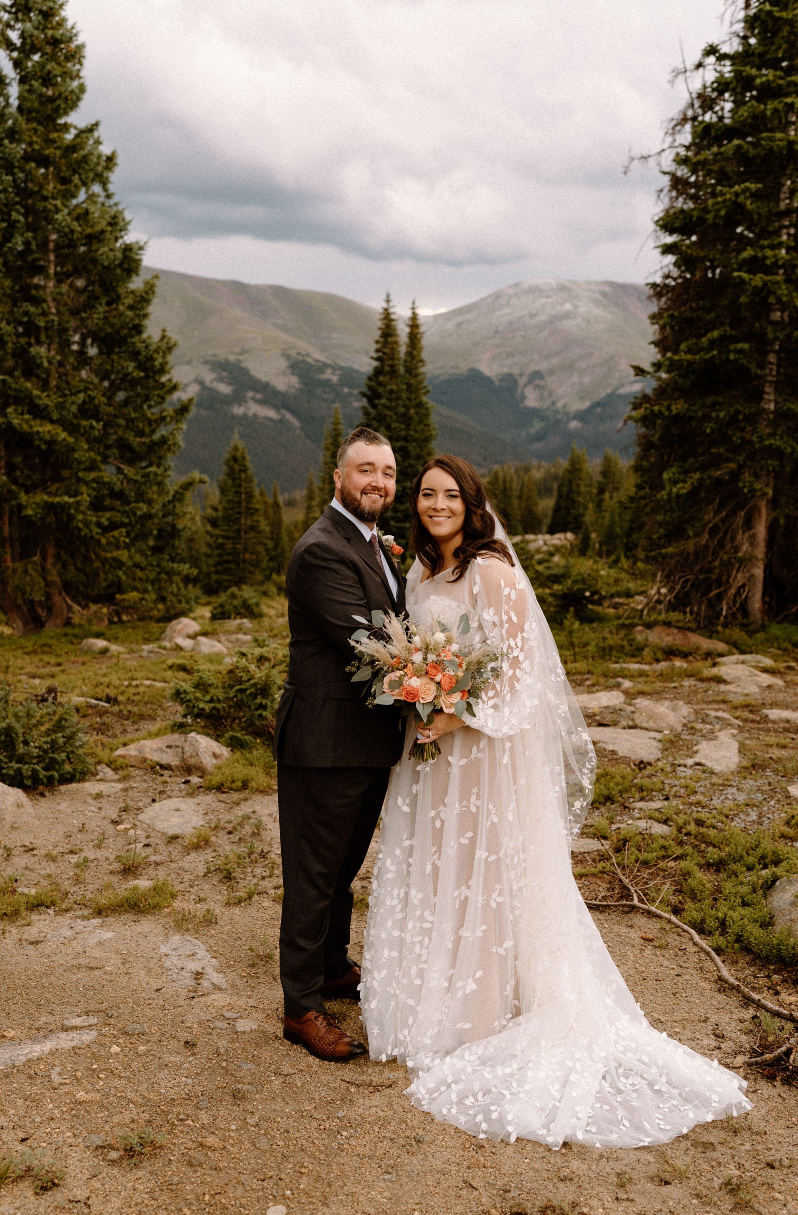 Bride and groom in front of the mountains at Lunch Rock in Winter Park, CO