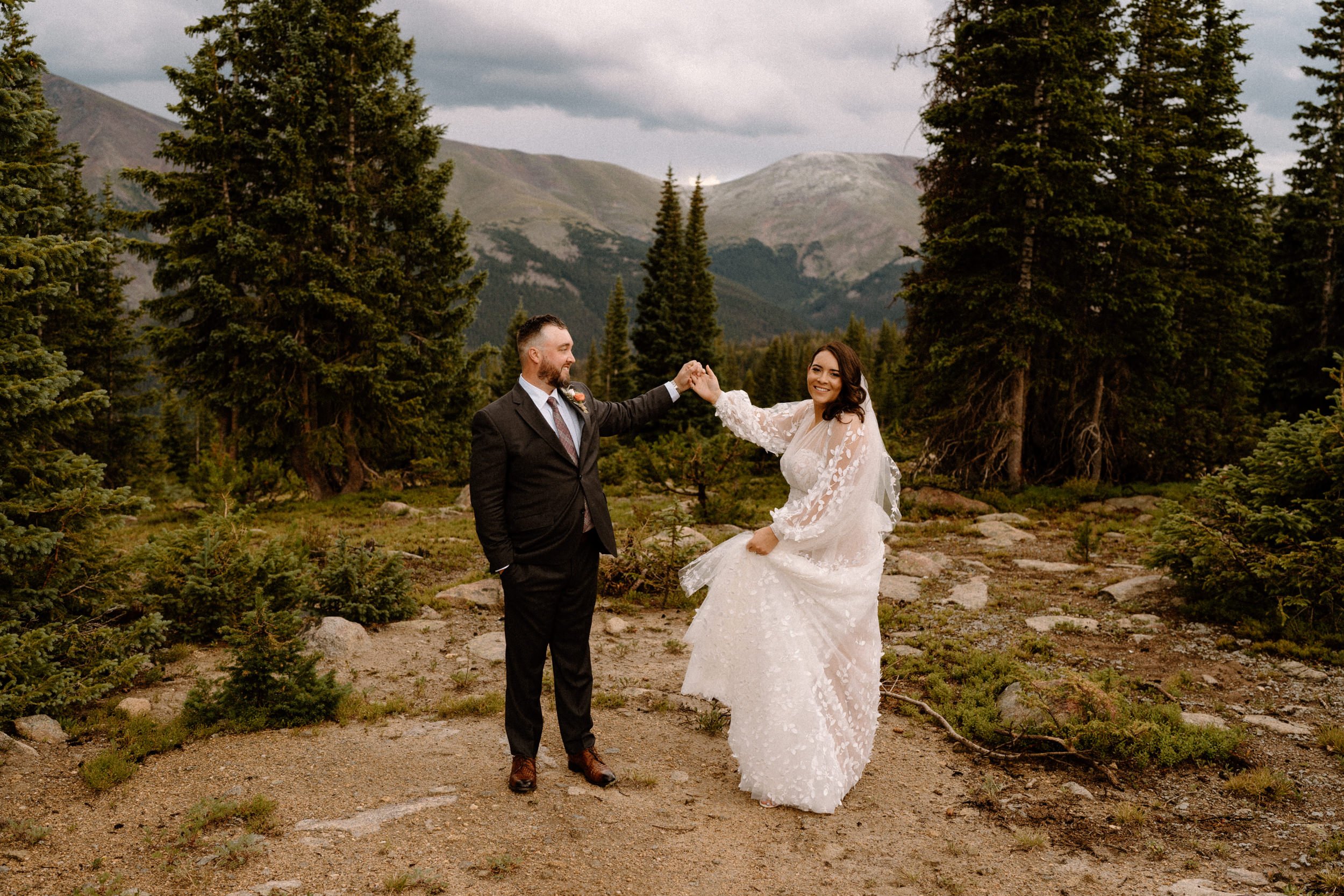 Groom twirls the bride at the top of Lunch Rock in Winter Park, CO