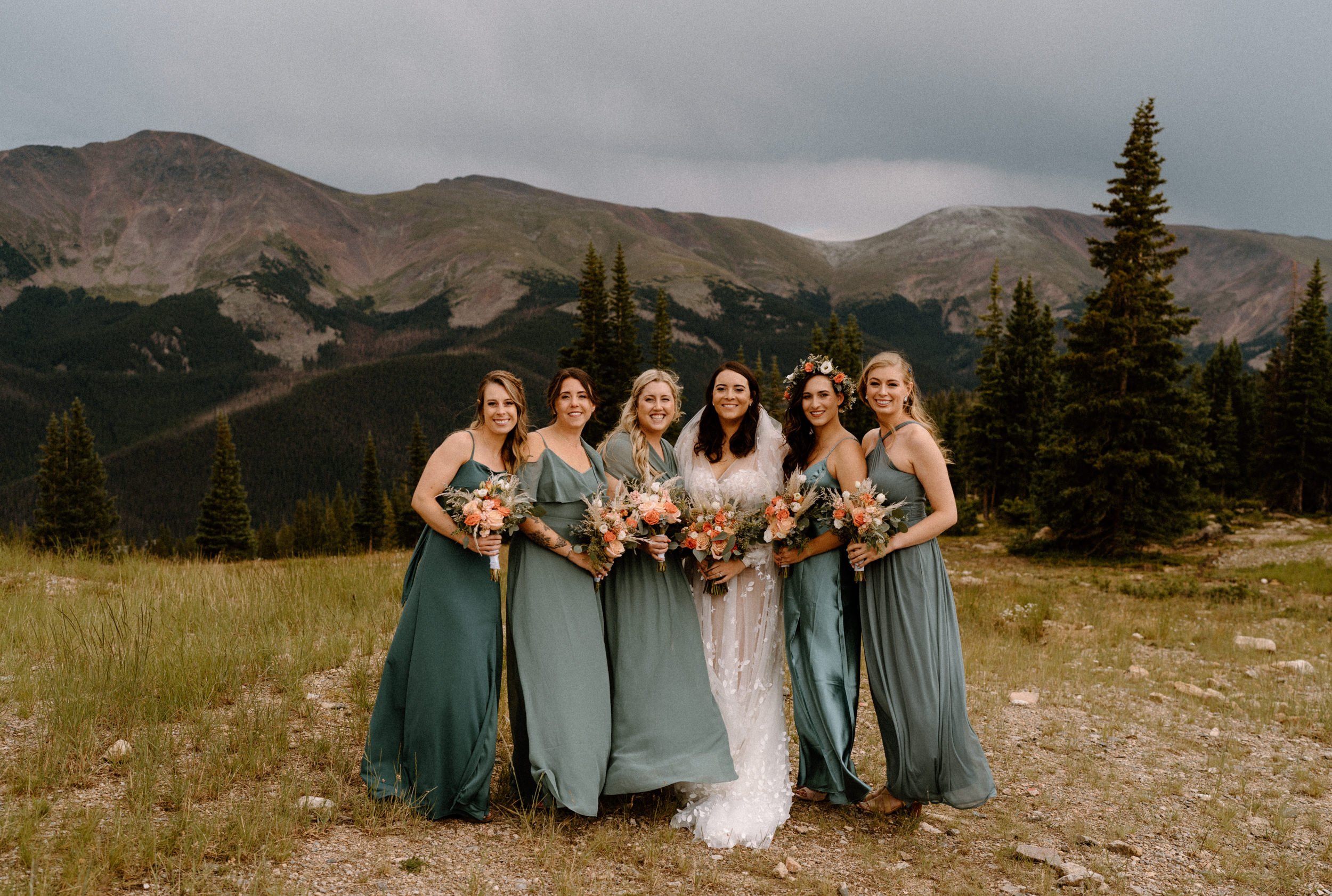 Bridal party poses on the top of Lunch Rock in Winter Park, CO