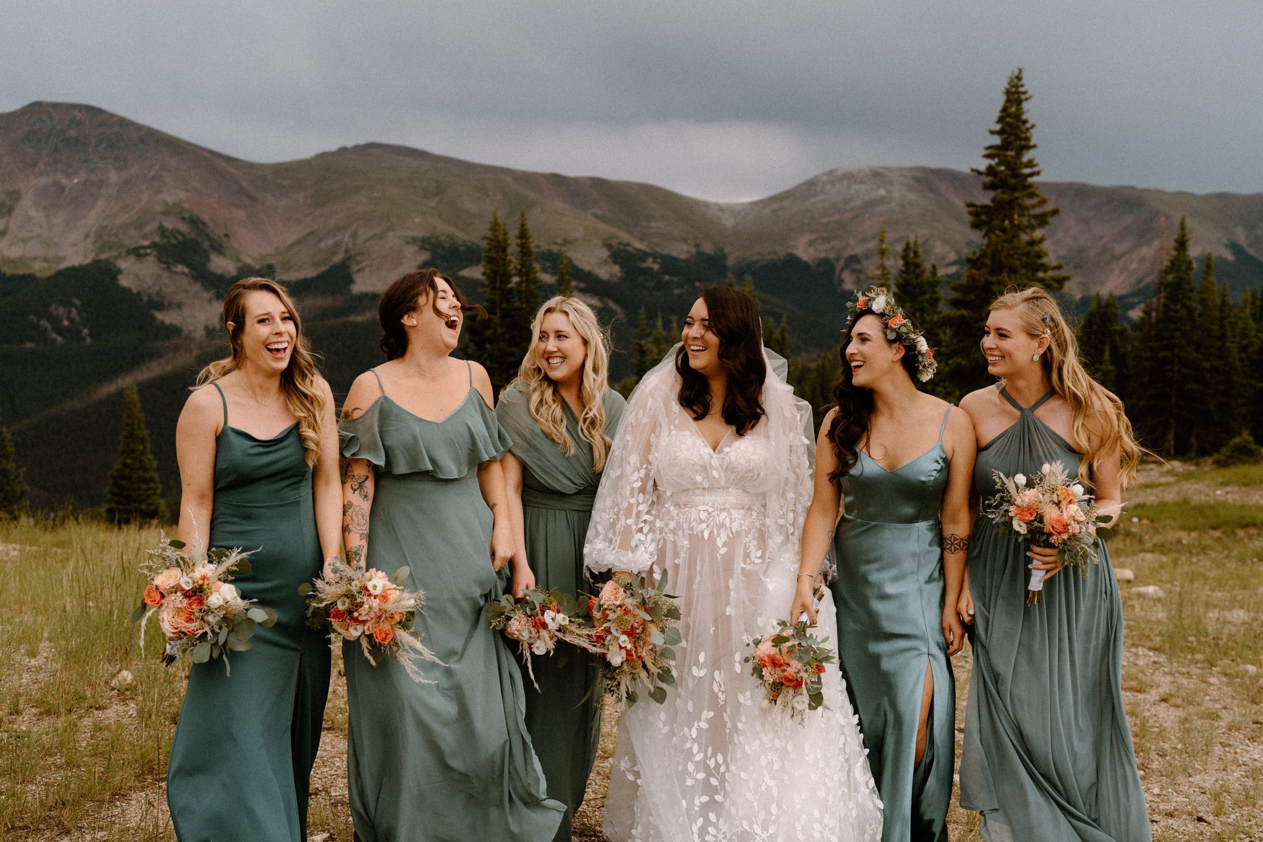 Bride laughs with her bridal party