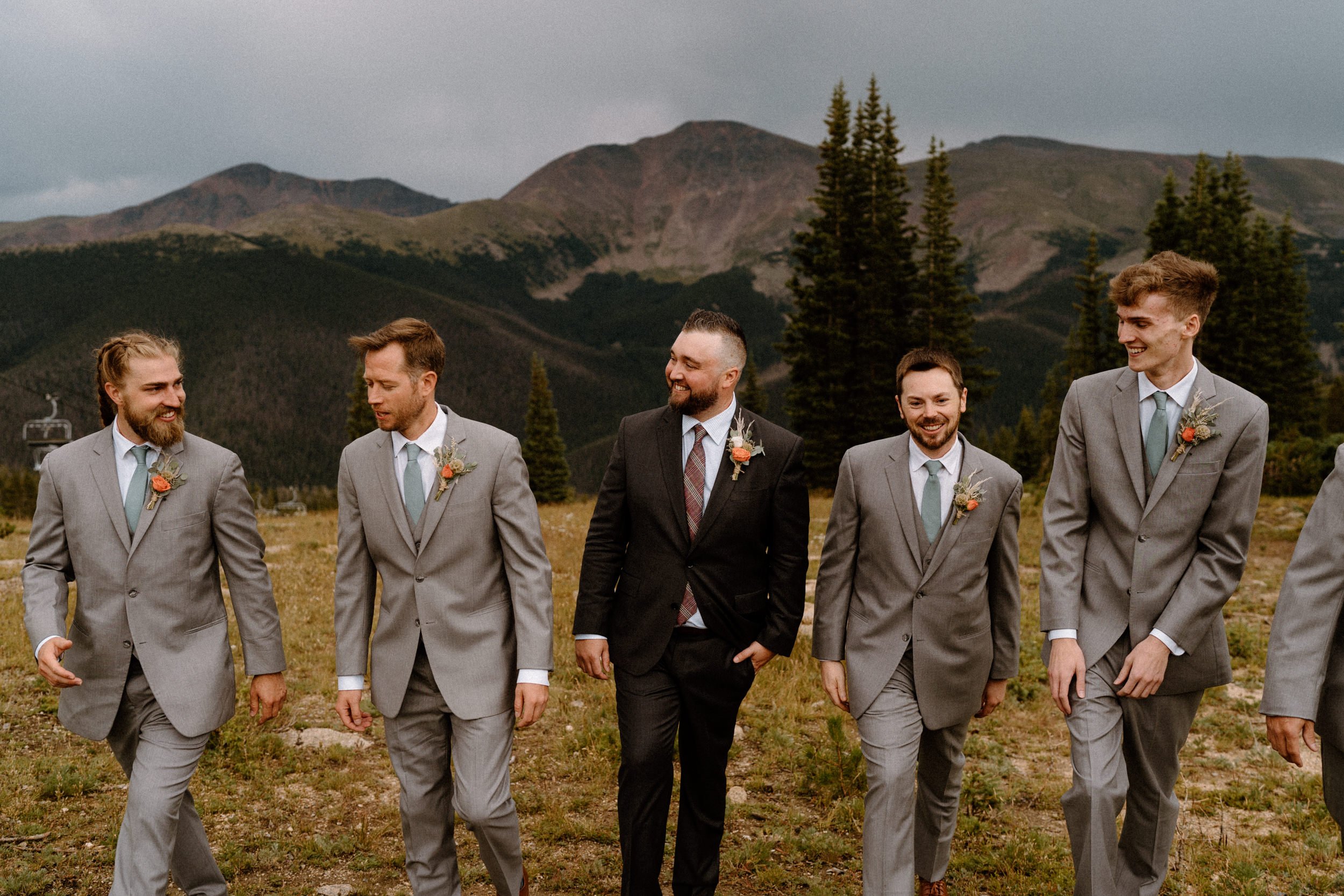 Groomsmen laugh and smile with each other