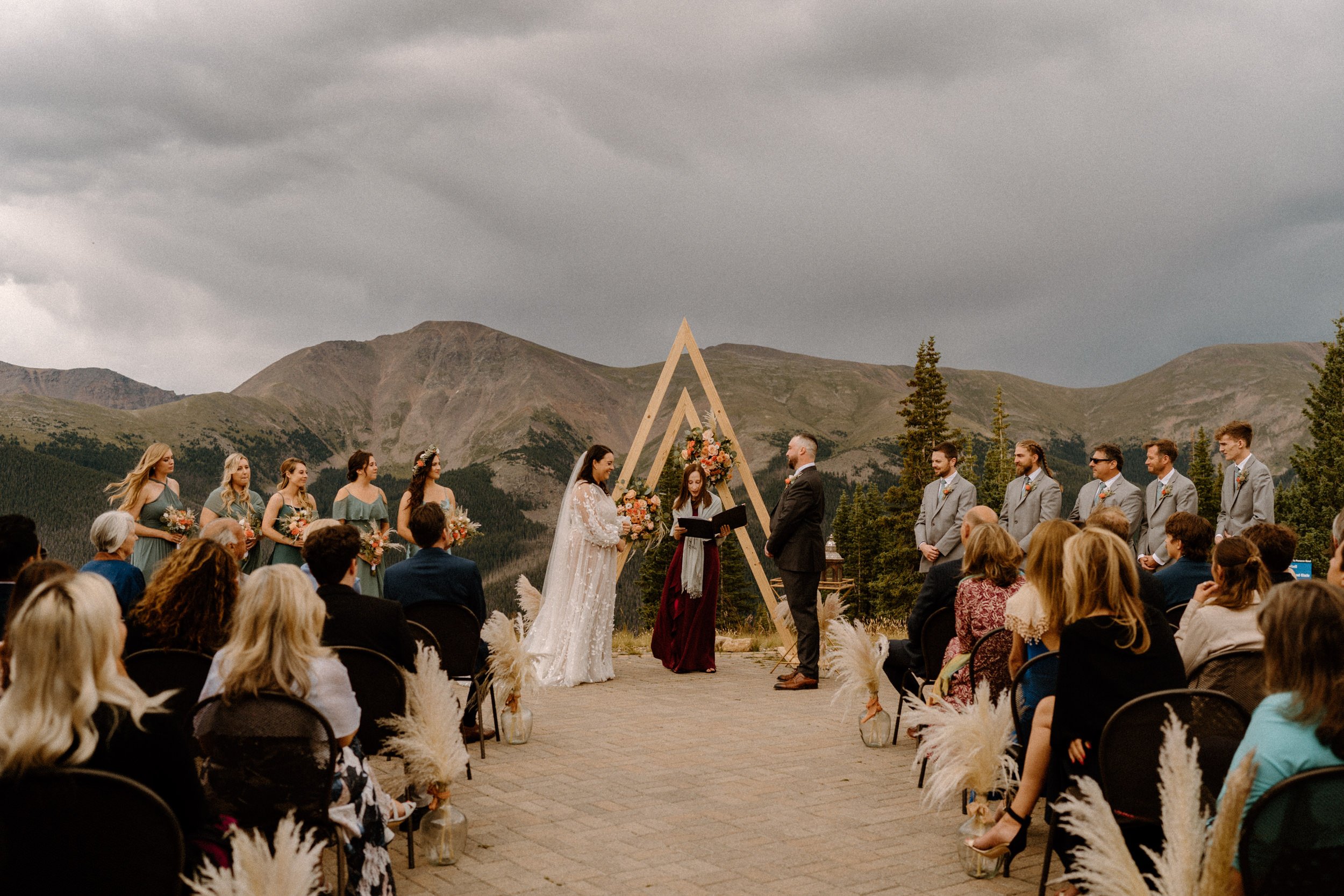 Bride and groom stand at the altar together at the top of Lunch Rock in Winter Park, CO