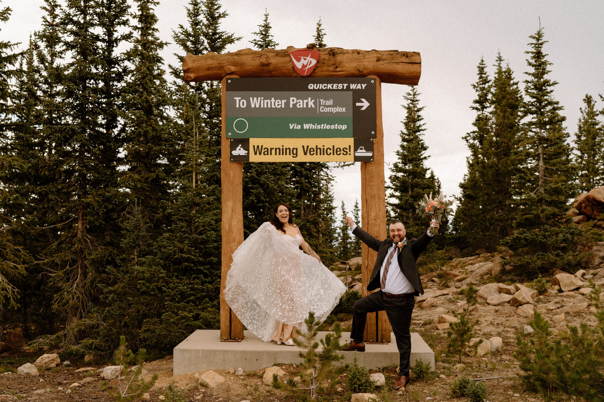 Bride and groom pose in front of Winter Park sign