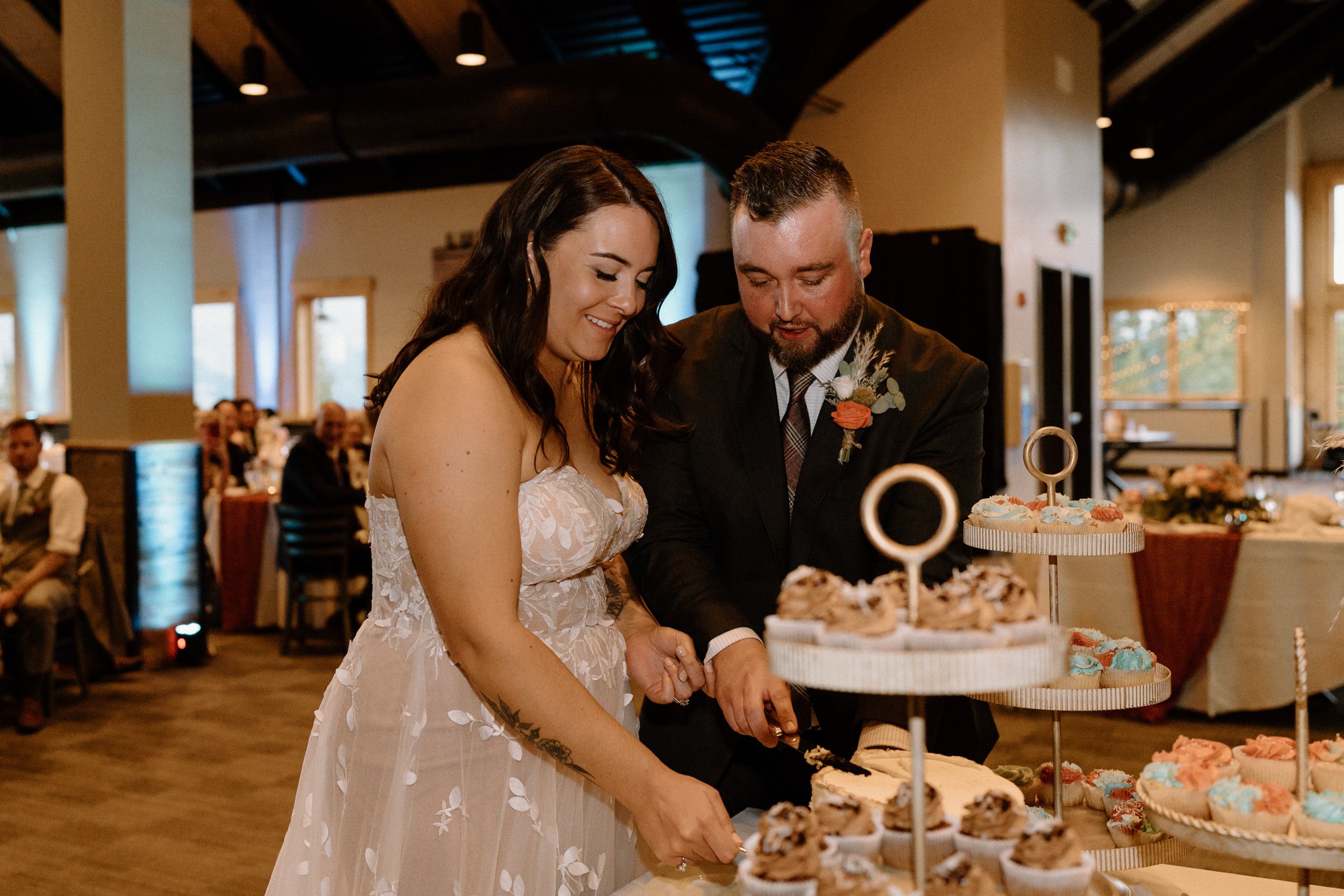 Bride and groom cut the wedding cake together