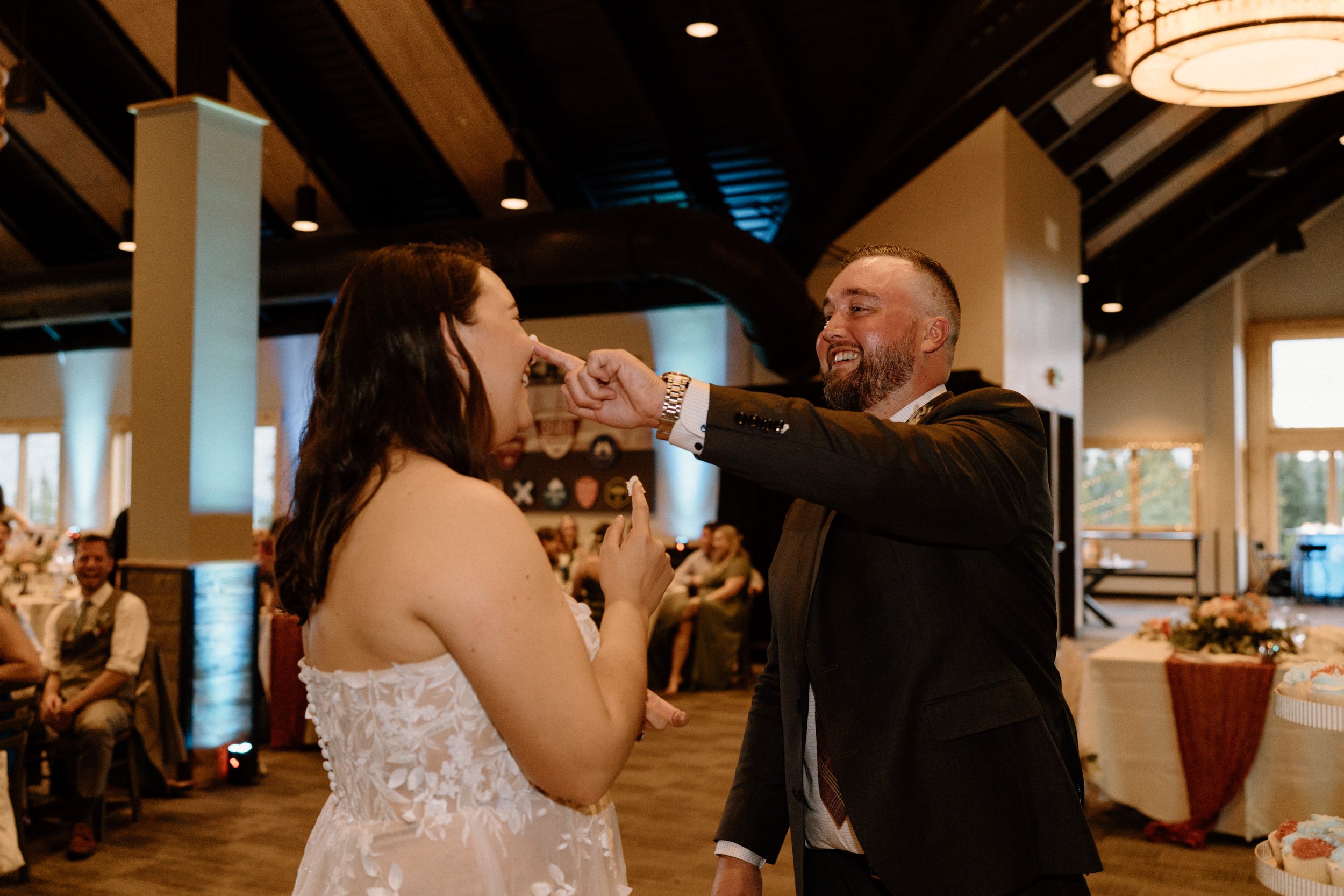 Bride and groom feed a piece of cake to each other