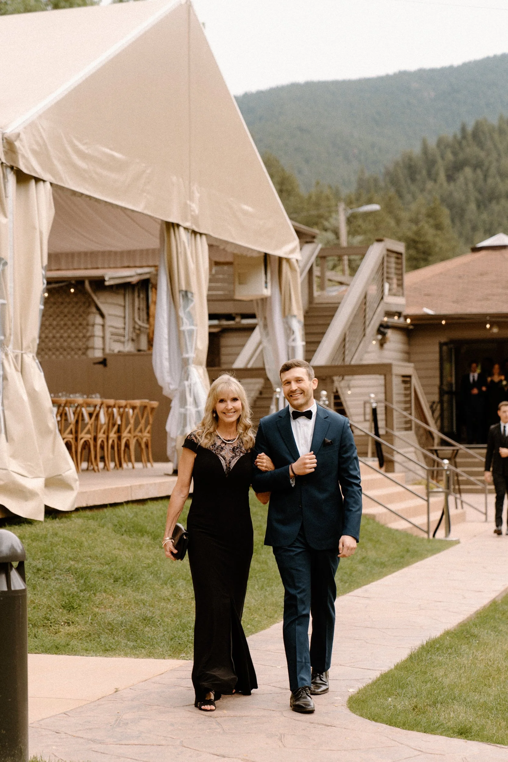 The groom walks his mother down the aisle