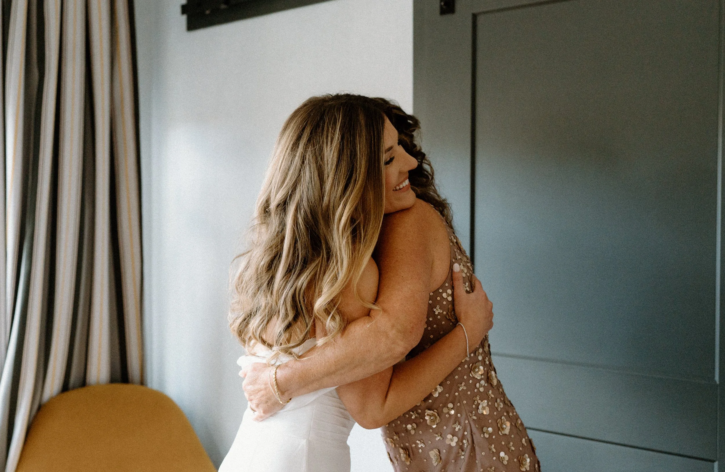 Bride and her mom hugging on wedding day at The Eddy in Golden Colorado