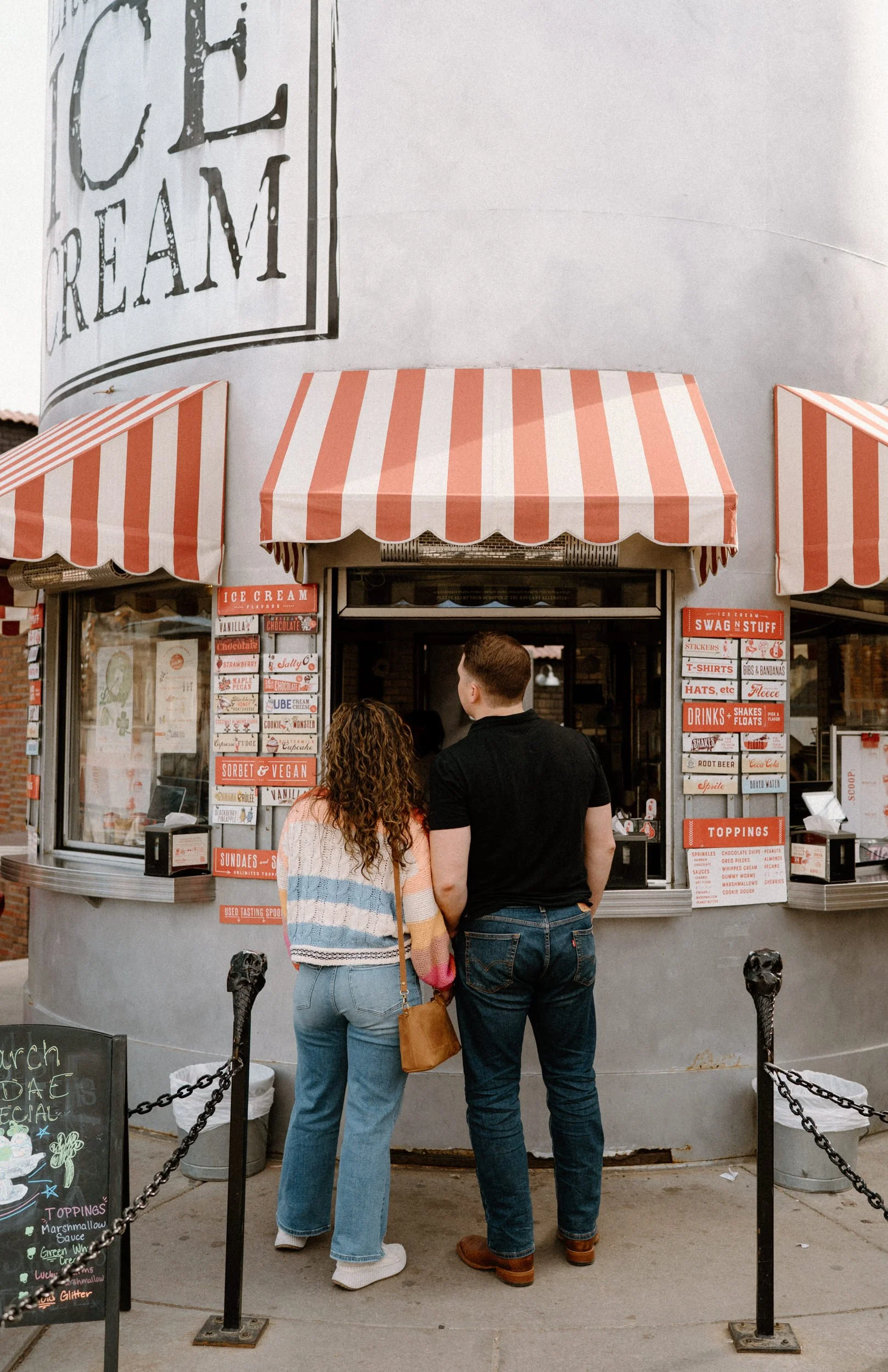 Couple ordering ice cream from Little Man during an engagement session