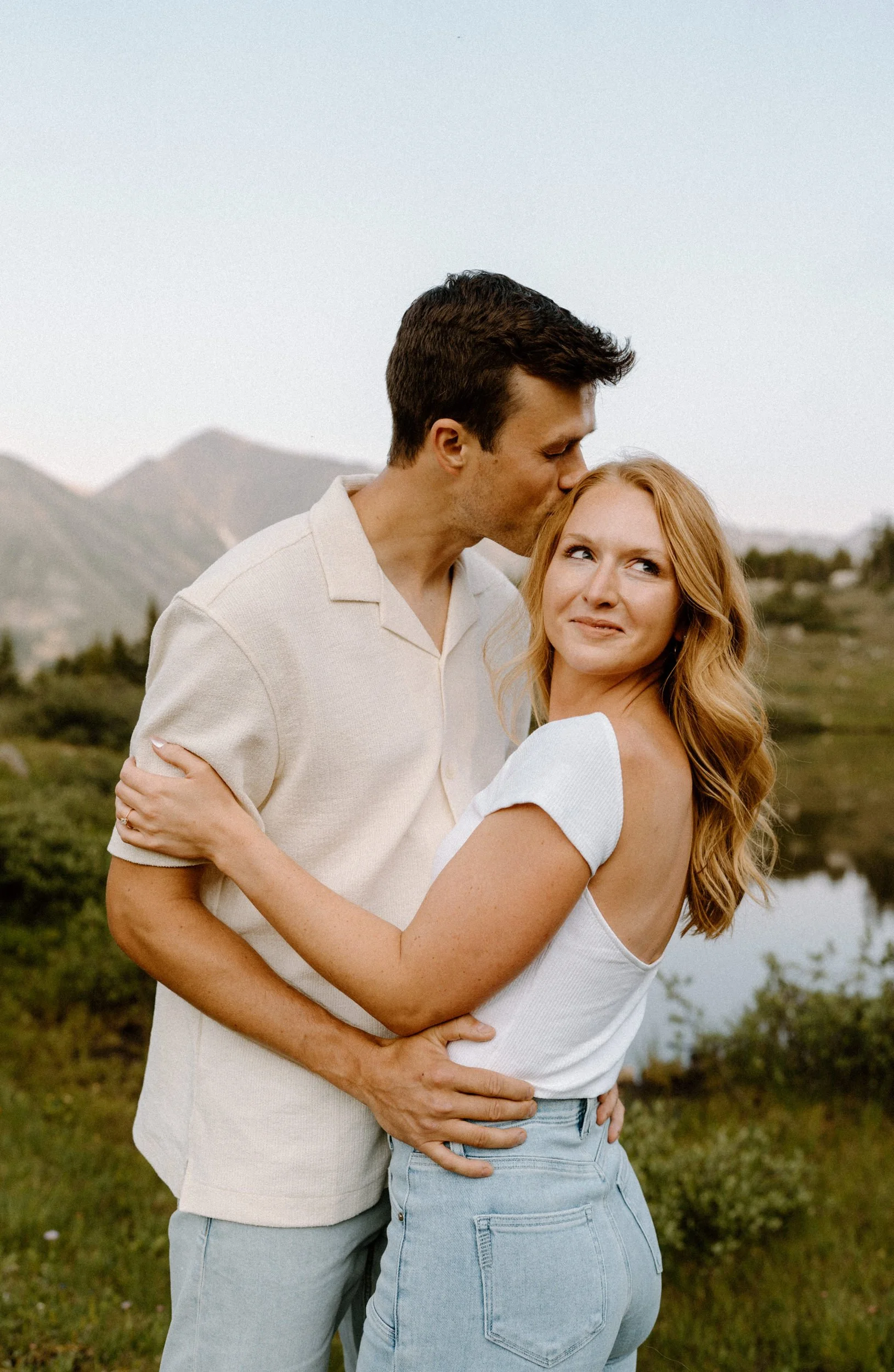 Fiancé kissing fiancées forehead during an engagement session at Loveland Pass