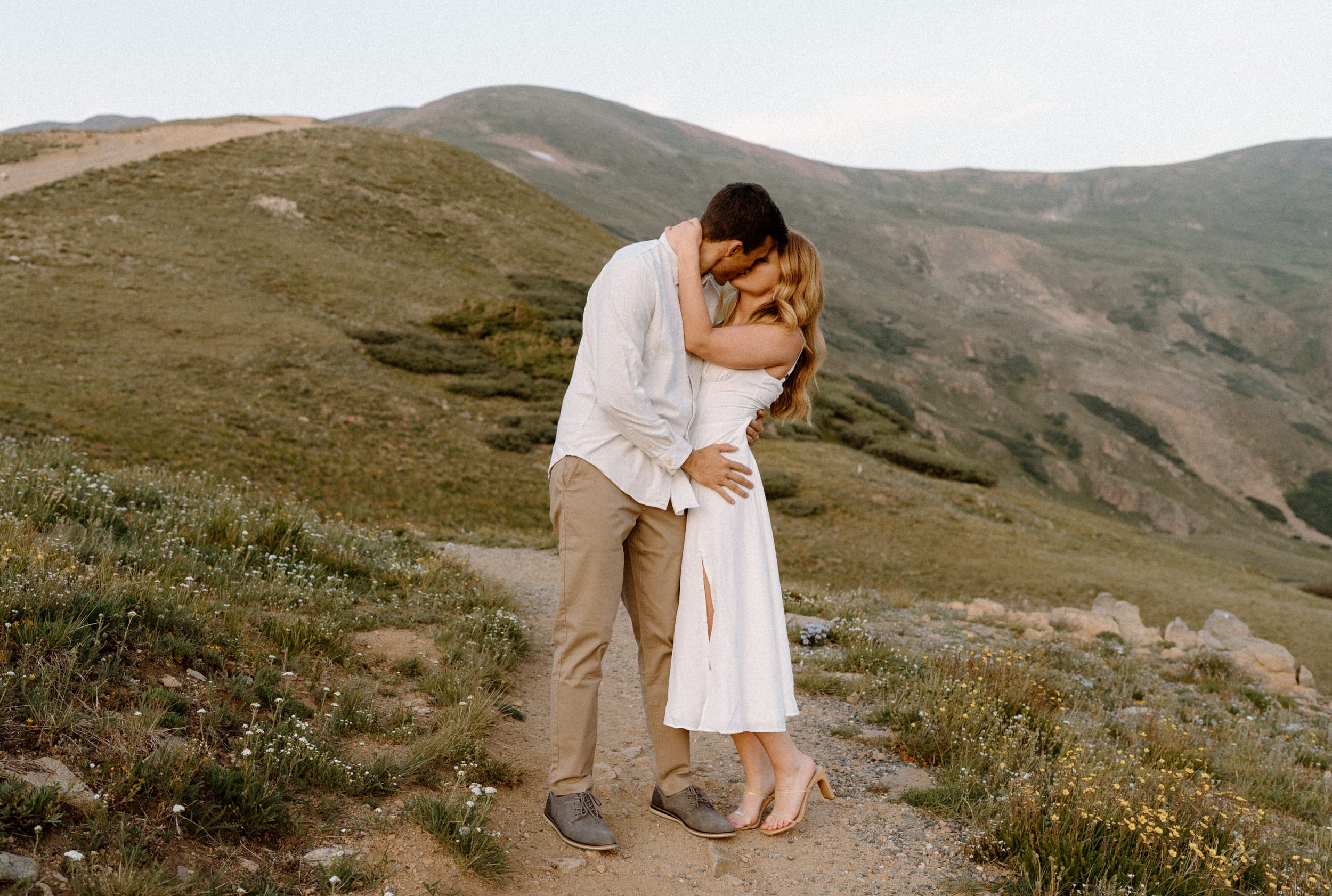 Couple kissing on a trail during an engagement session at Loveland Pass