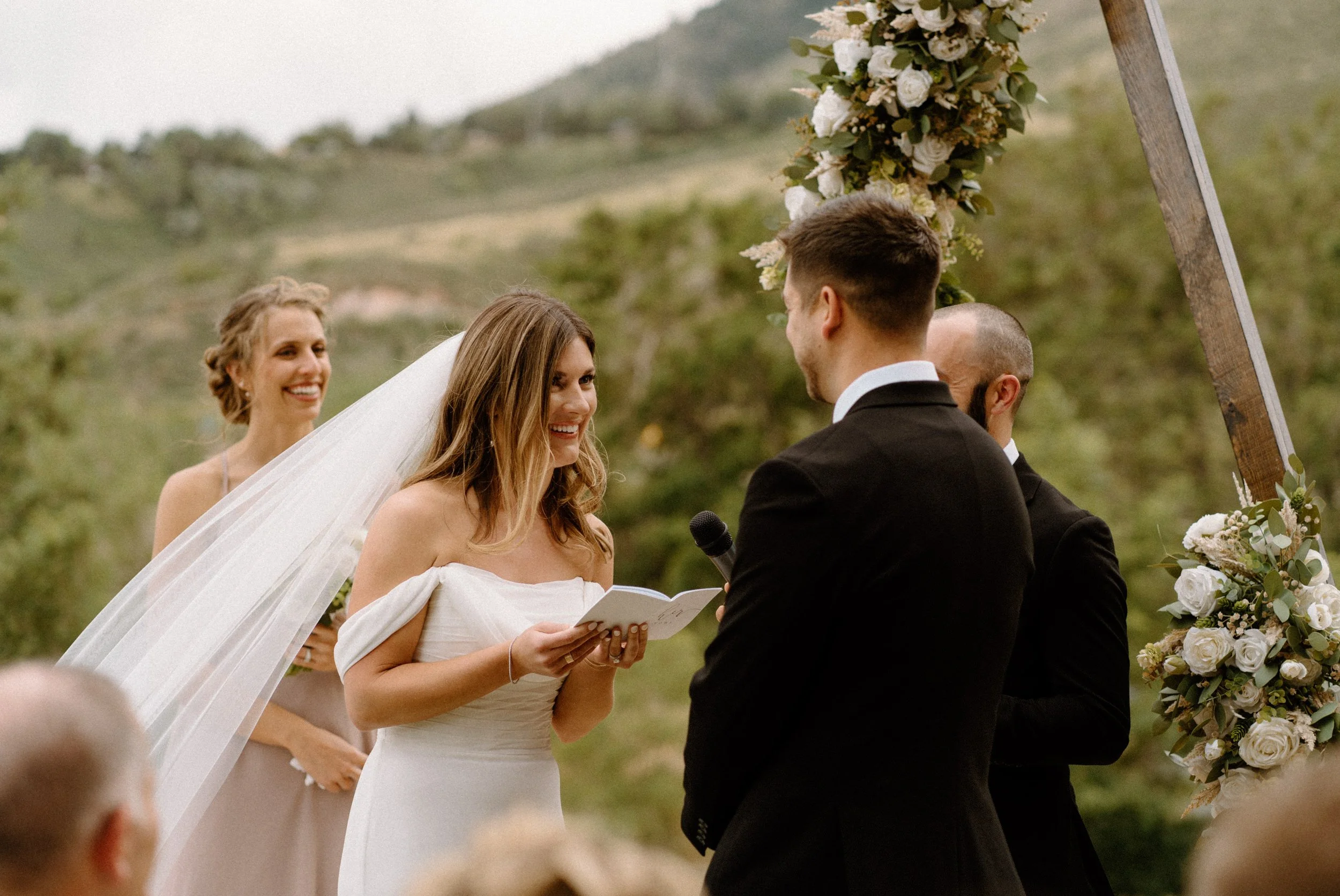 Bride smiling during vows at the alter on wedding day at The Eddy in Golden Colorado