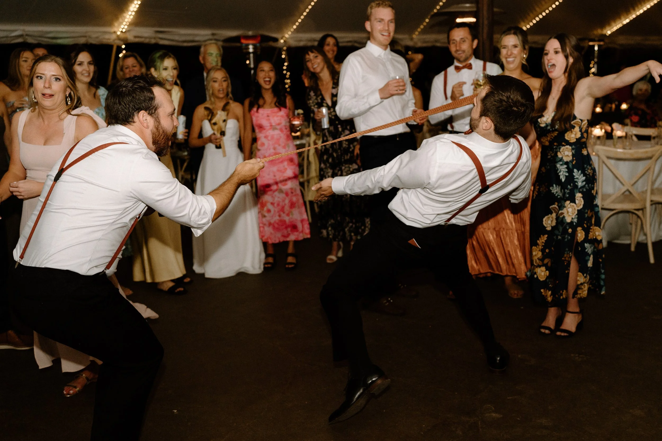 Groom doing the limbo on wedding day at Blackstone Rivers Ranch