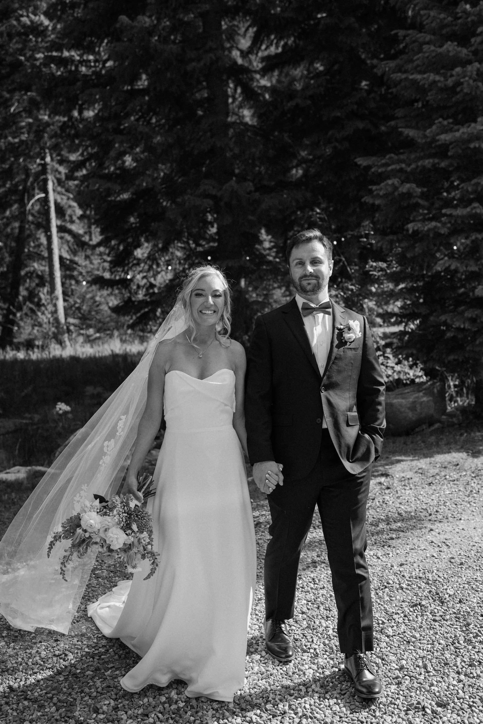 Bride and groom smiling at the camera on wedding day at Blackstone Rivers Ranch