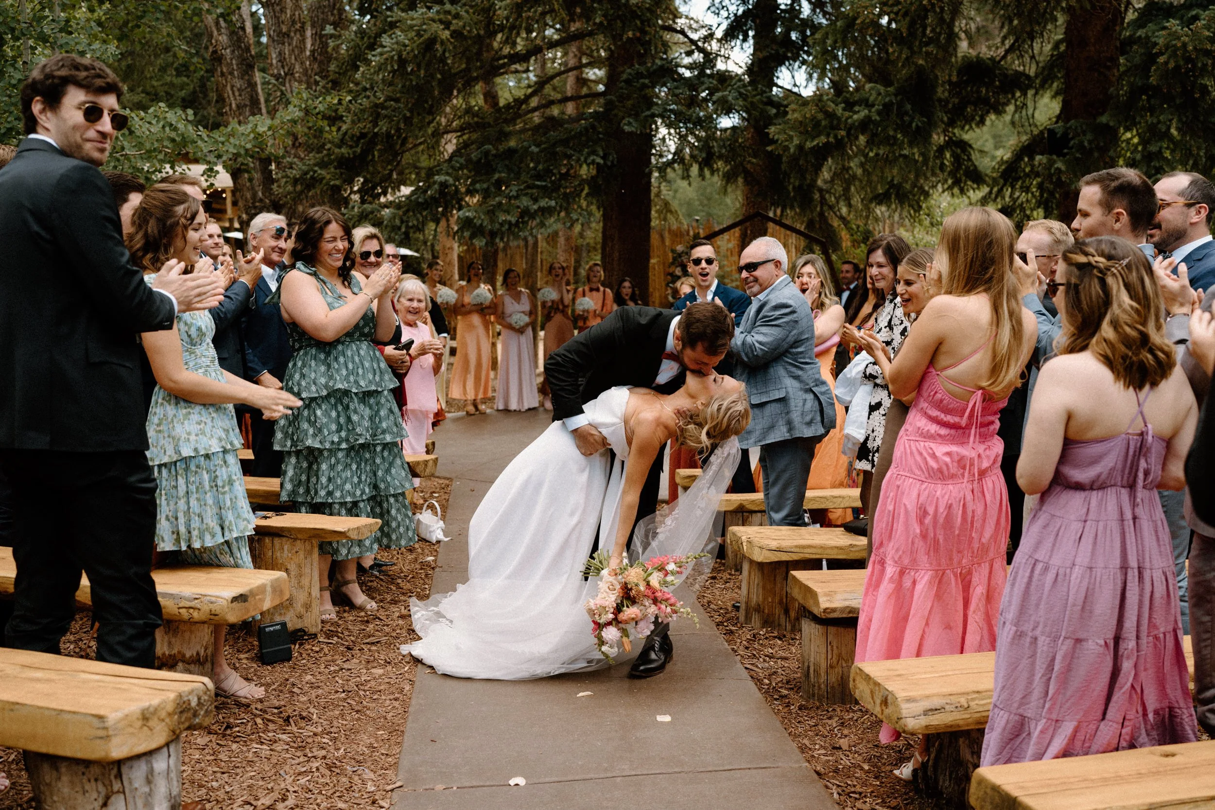 Groom dipping bride and kissing her on wedding day at Blackstone Rivers Ranch