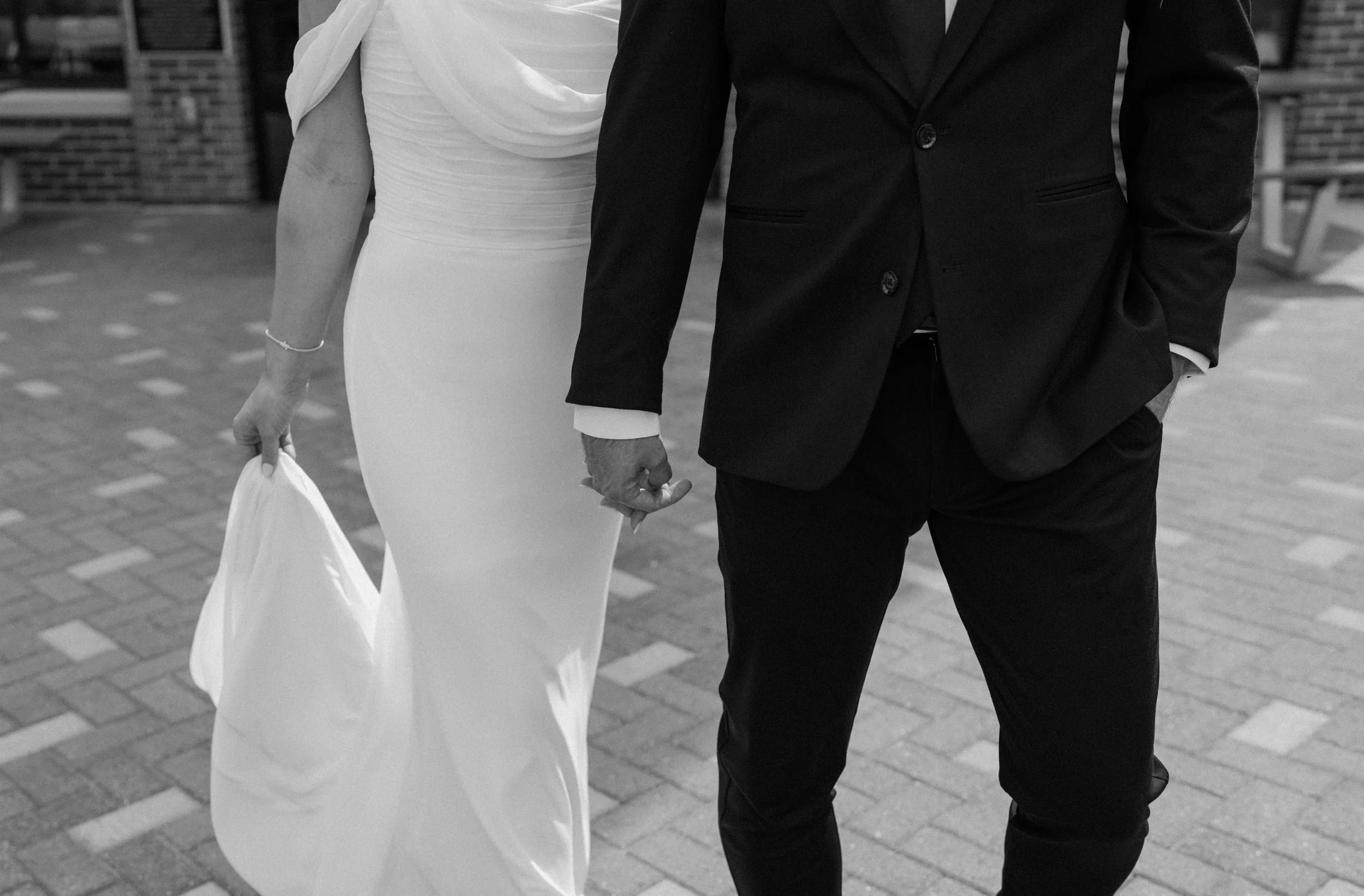 Bride and groom holding hands at The Eddy in Golden Colorado on wedding day