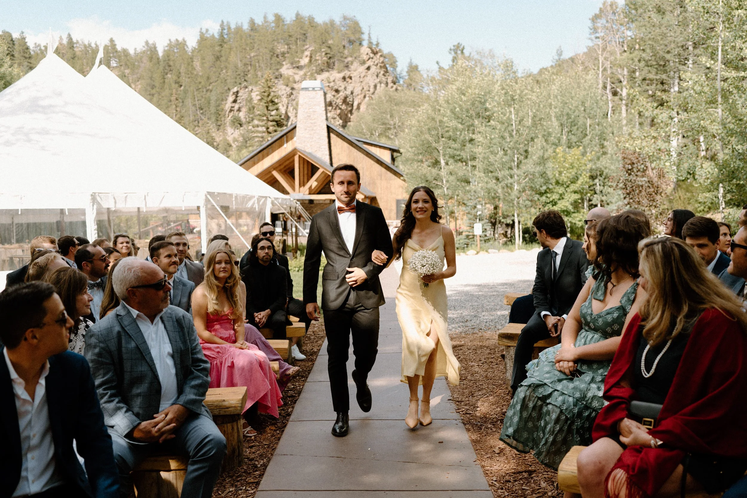 Groomsmen and bridesmaid walking down the aisle on wedding day at Blackstone Rivers Ranch