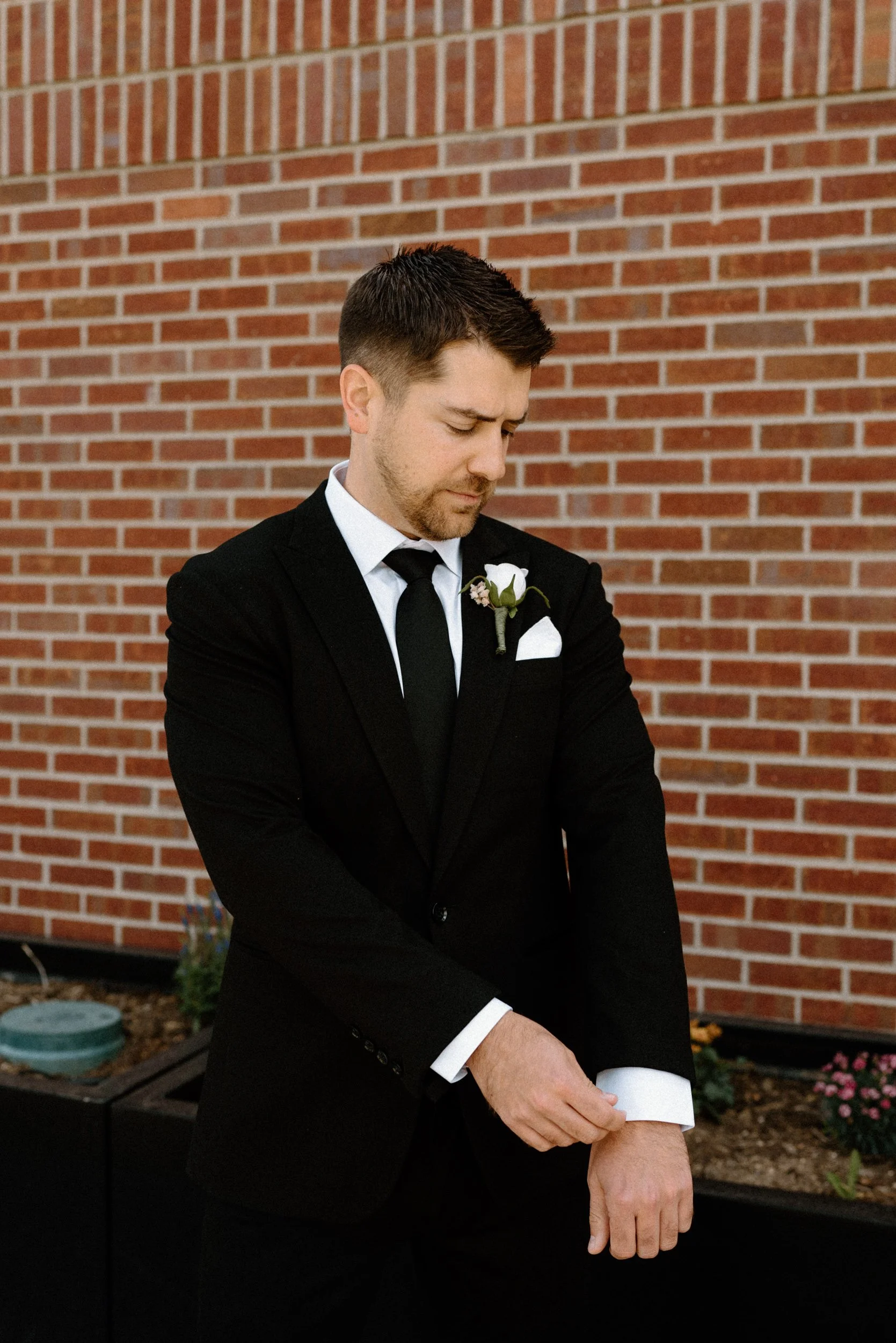 Groom fixing his cuff on wedding day at The Eddy in Golden Colorado