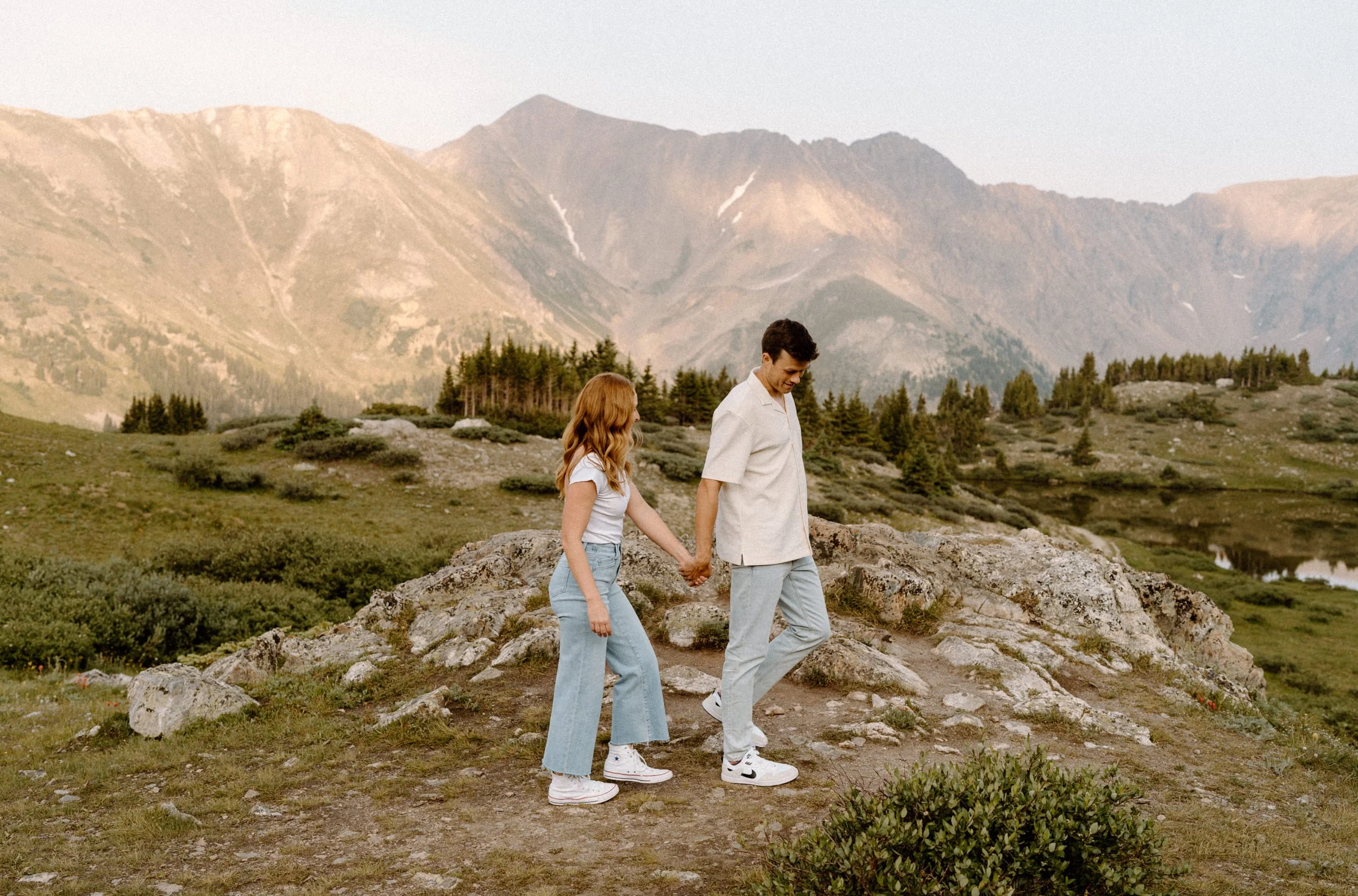 Couple holding hands and hiking at Loveland Pass during an engagement photoshoot