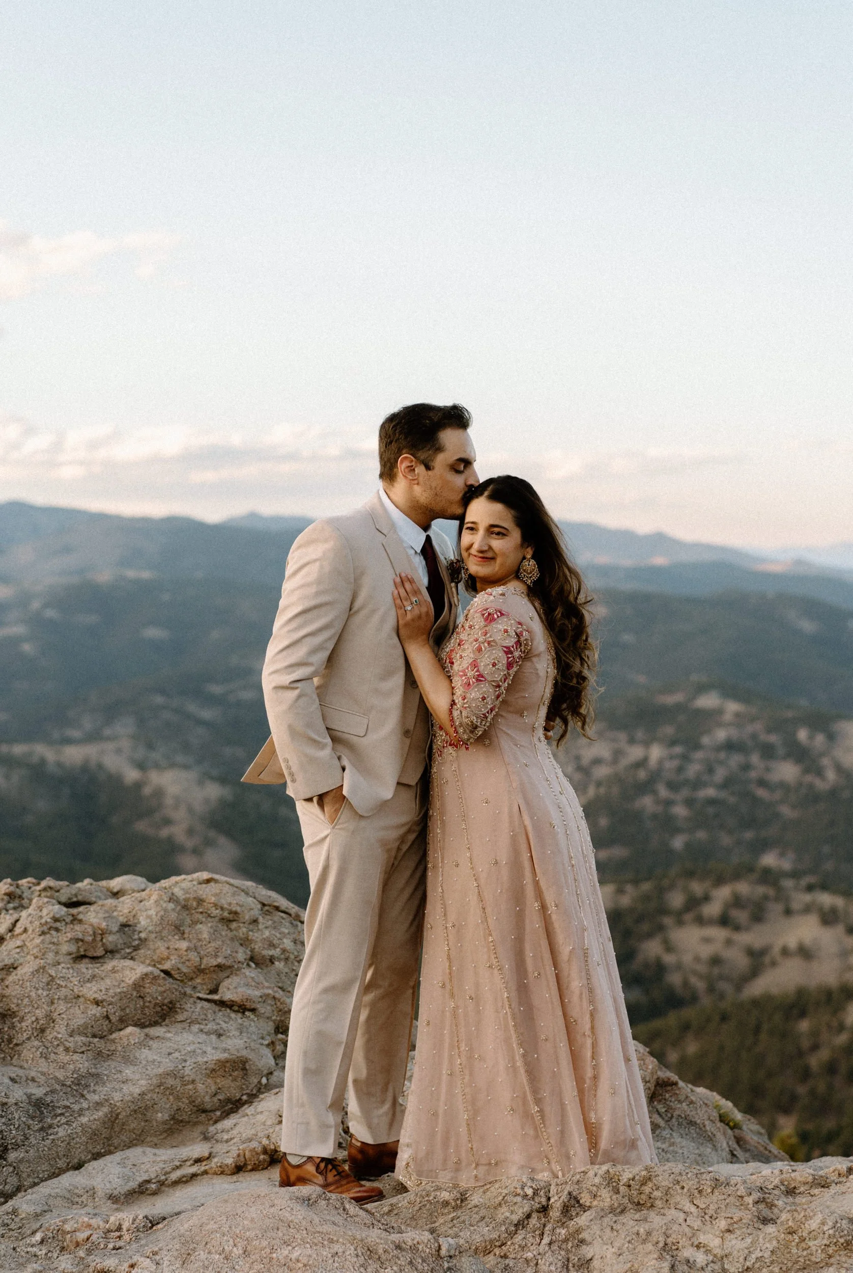 Fiancé kissing fiancées forehead in Boulder Colorado during an engagement session