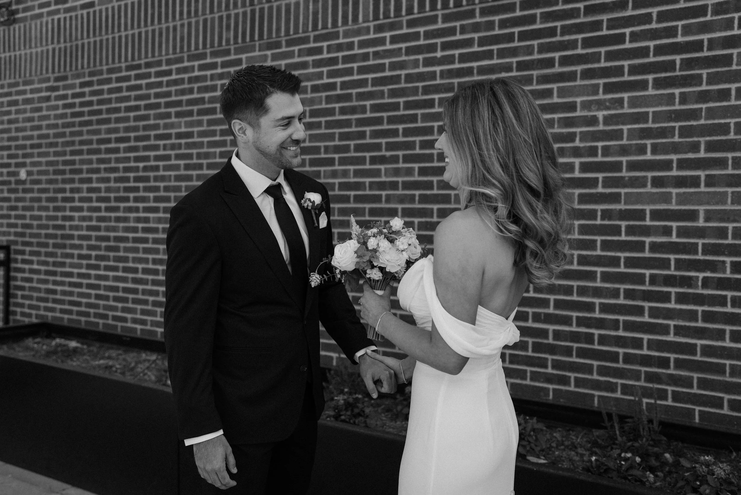 Bride and groom laughing during their first look on wedding day at The Eddy in Golden Colorado