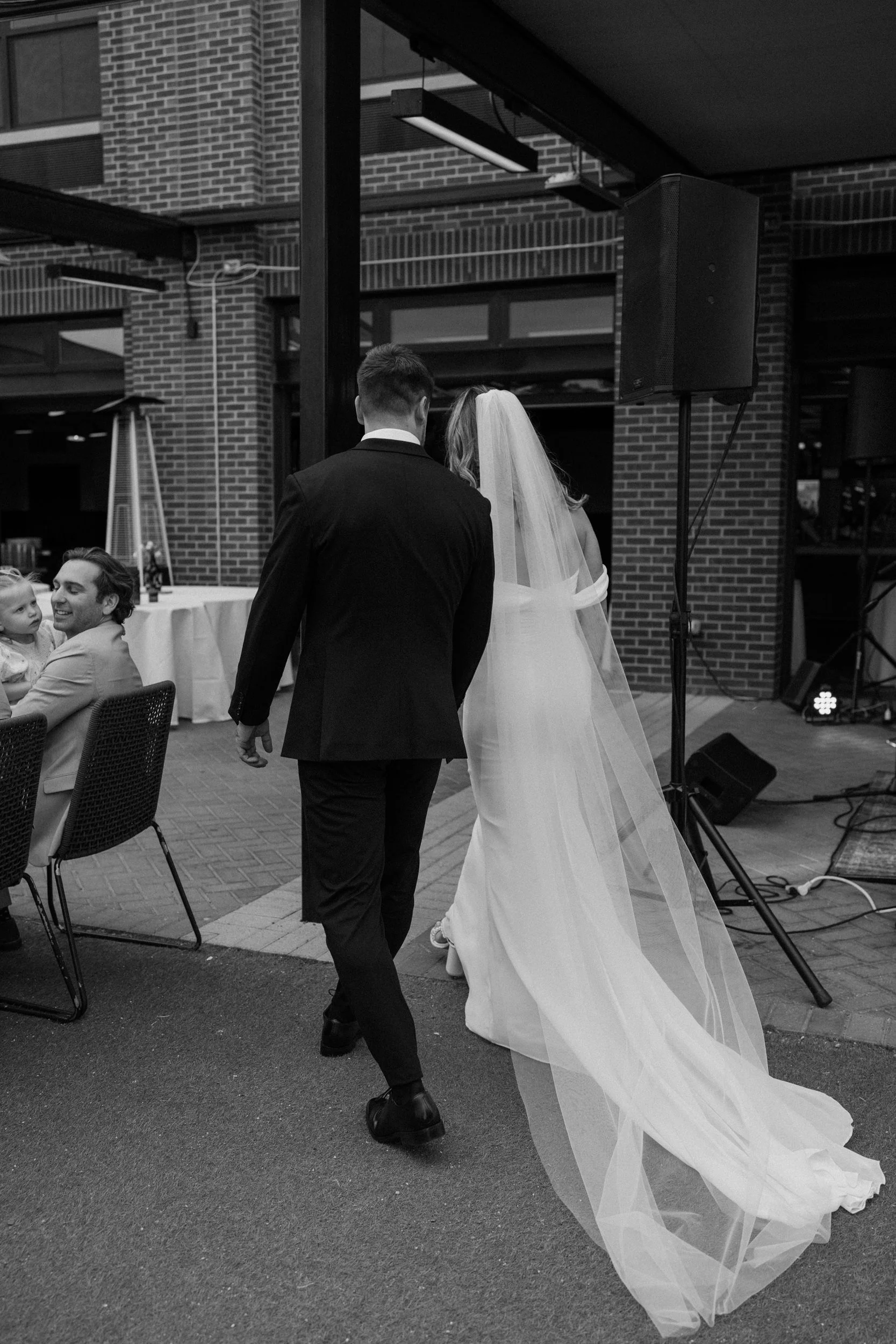 Bride and groom walking away from ceremony on wedding day at The Eddy in Golden Colorado