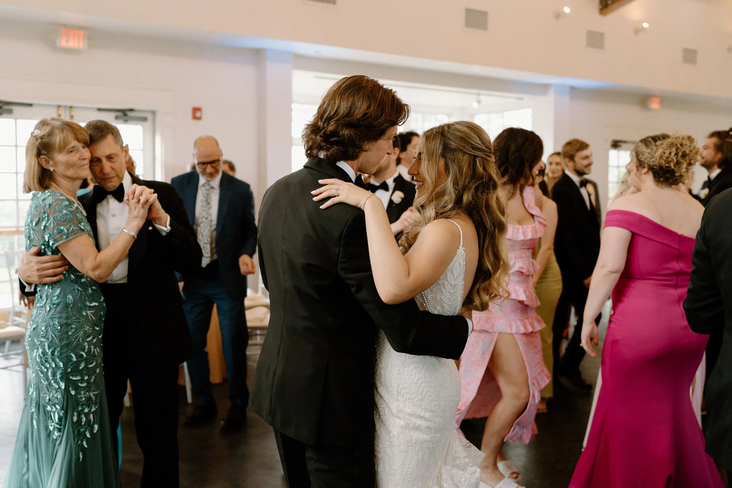 Bride and groom dancing with family on wedding day at The Manor House