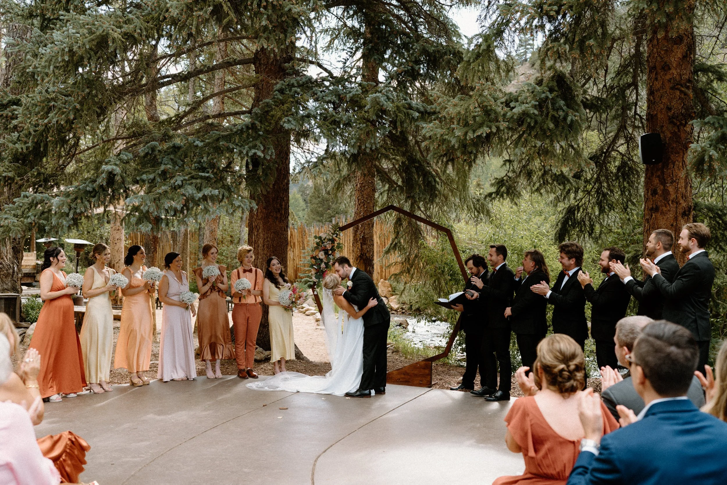 Bride and groom kissing during ceremony at Blackstone Rivers Ranch on wedding day