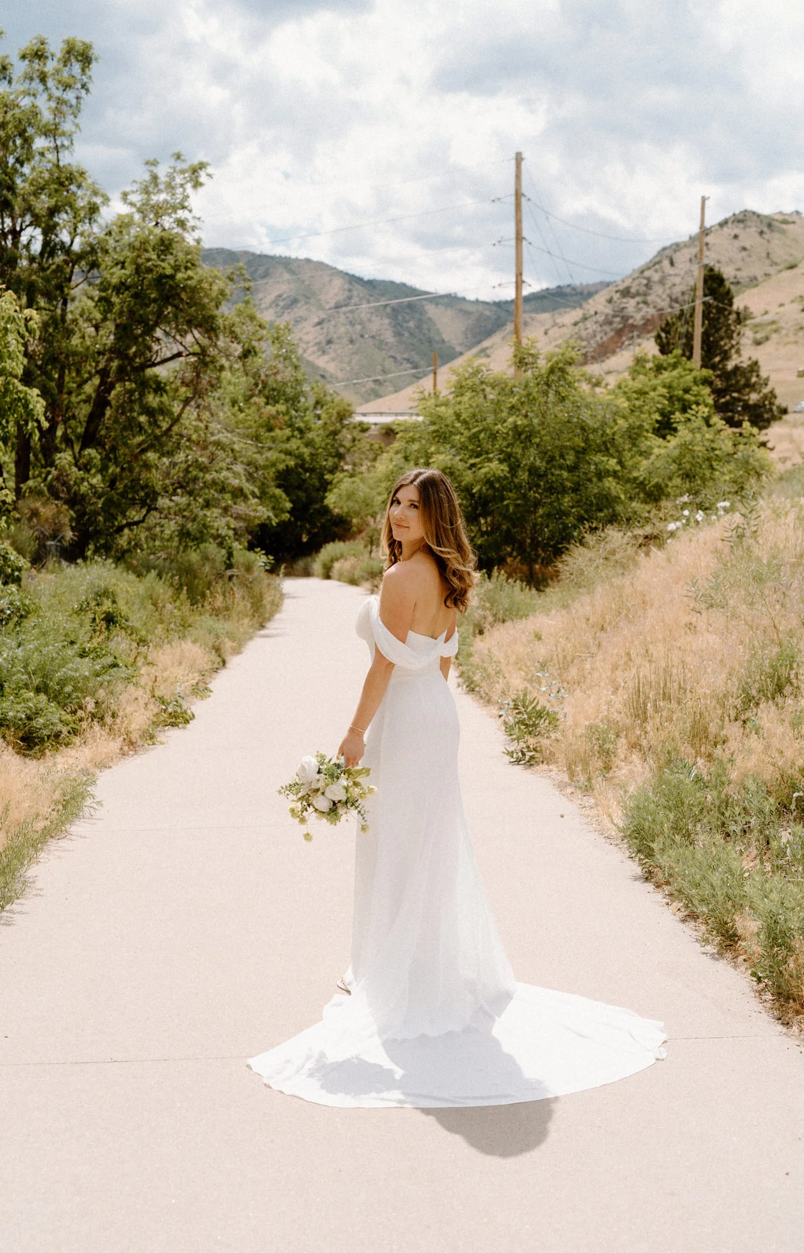 Bride standing on a path on wedding day at The Eddy in Golden Colorado
