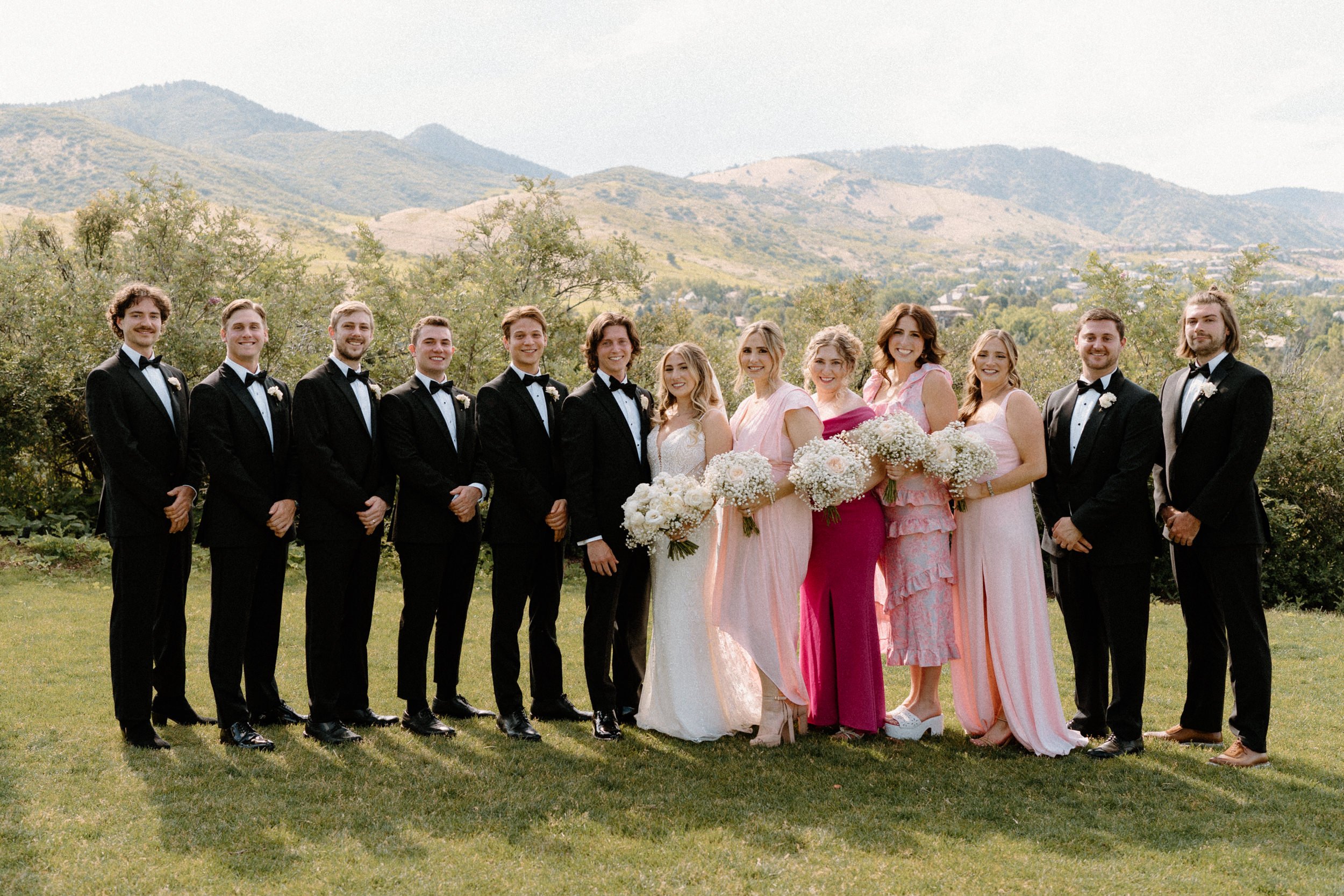 Wedding party smiling at the camera on wedding day at The Manor House