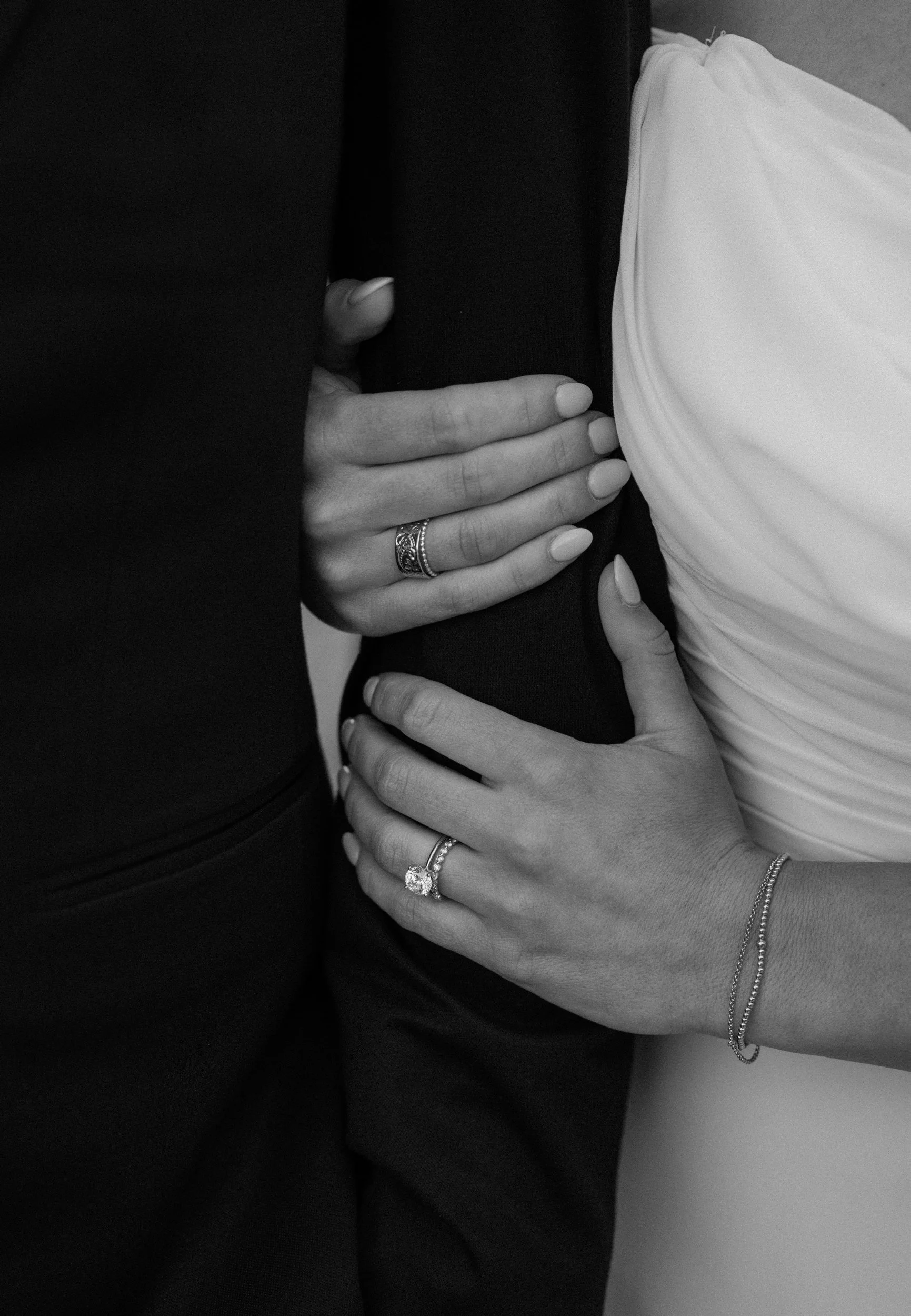 Bride holding groom's arm showing wedding ring on wedding day at The Eddy in Golden Colorado