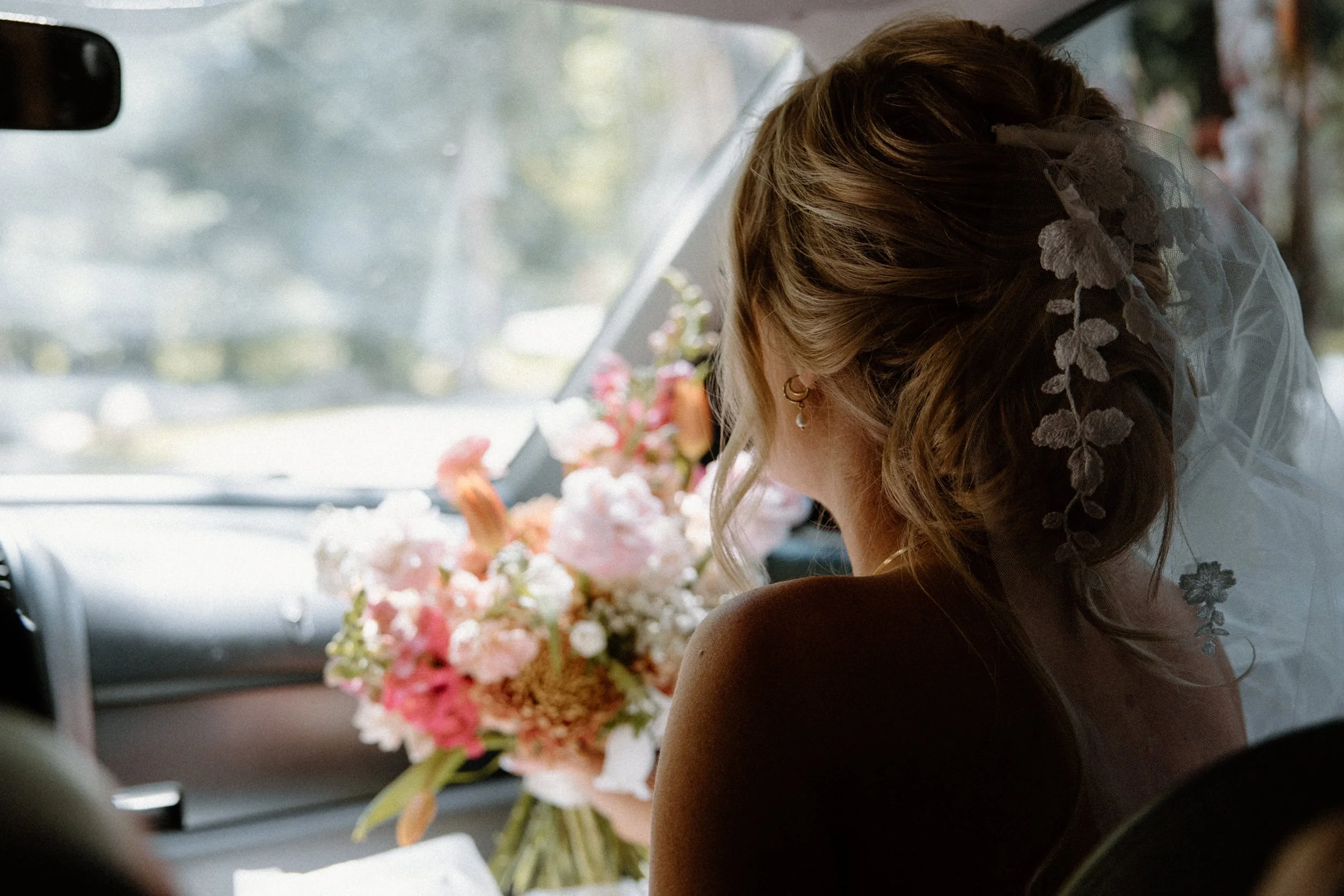Bride driving in a car on wedding day at Blackstone Rivers Ranch